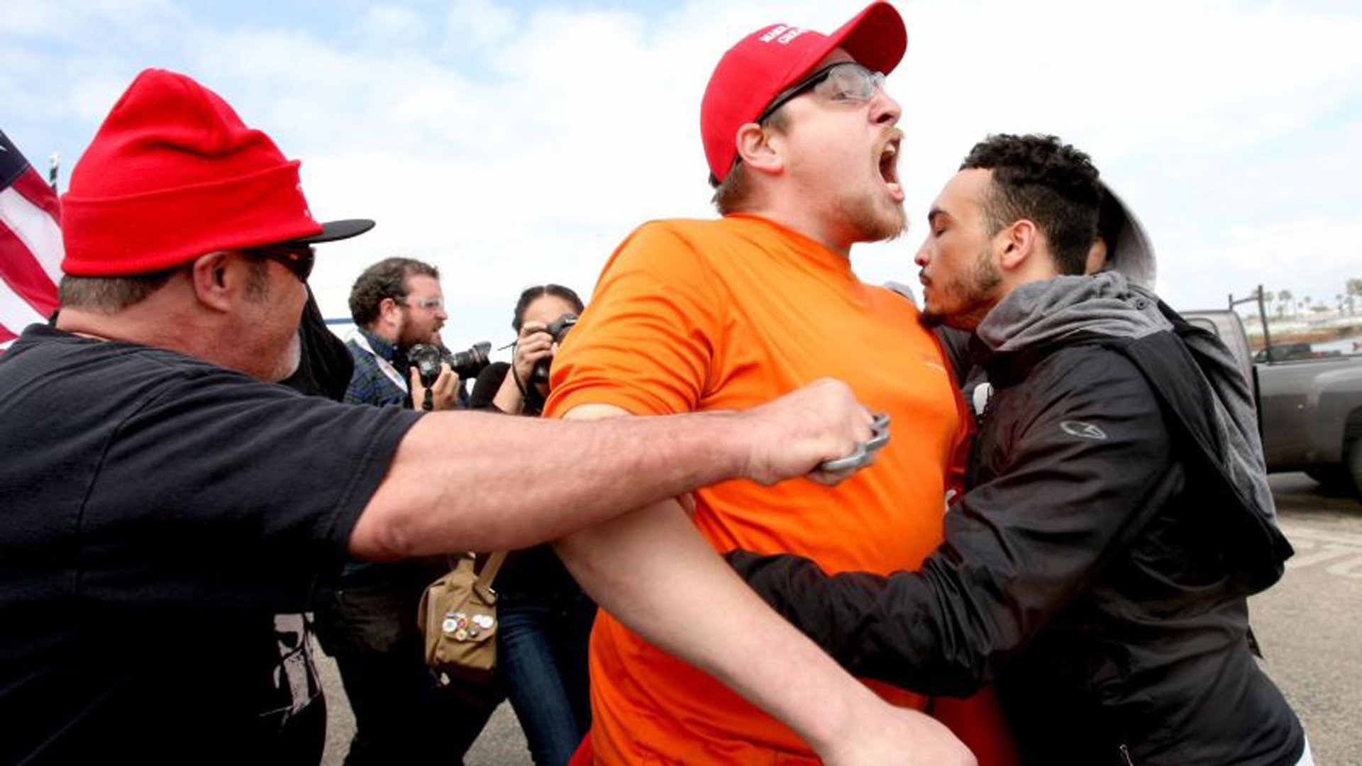 A protester at a “Make America Great Again” march wears brass knuckles at Bolsa Chica State Beach in March 2017. (Credit: Los Angeles Times)