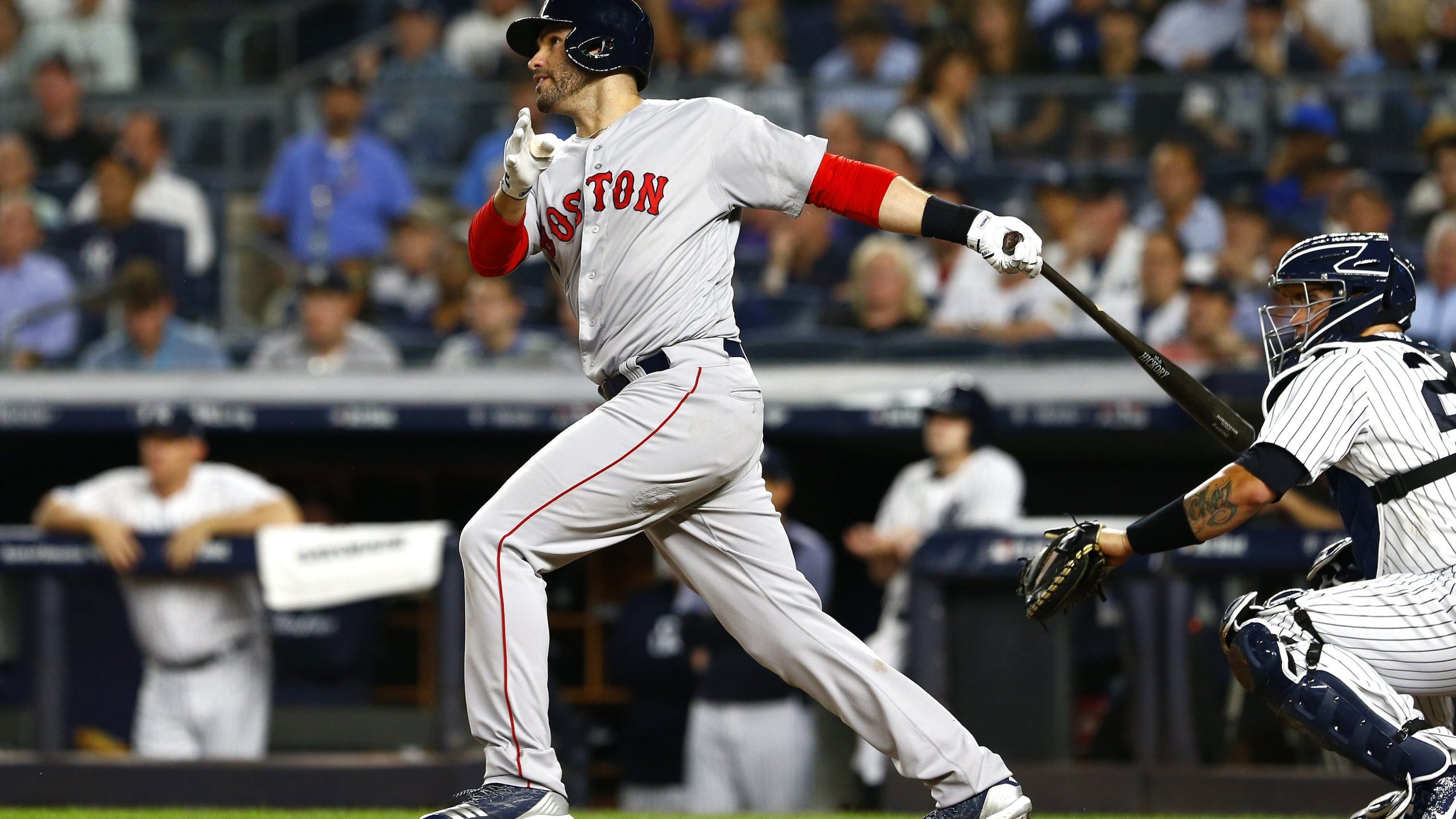 J.D. Martinez #28 of the Boston Red Sox hits a sacrifice fly RBI to score Andrew Benintendi #16 against CC Sabathia #52 of the New York Yankees during the third inning in Game Four of the American League Division Series at Yankee Stadium on Oct. 9, 2018. (Credit: Mike Stobe/Getty Images)