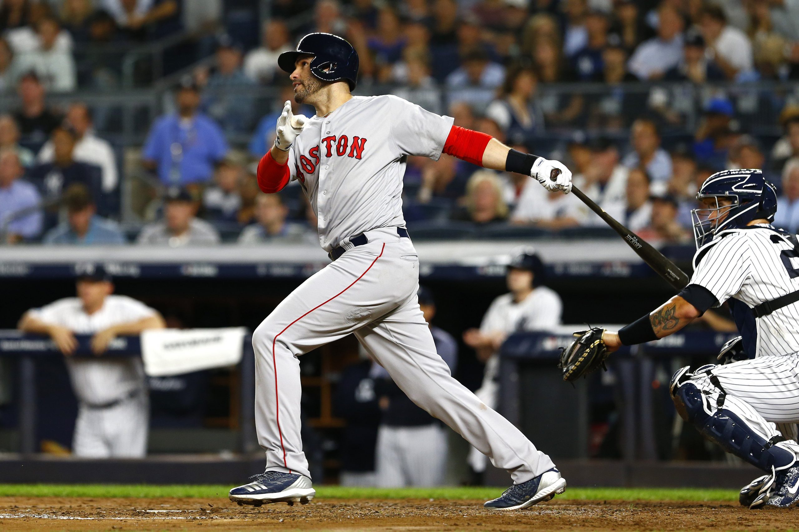 J.D. Martinez #28 of the Boston Red Sox hits a sacrifice fly RBI to score Andrew Benintendi #16 against CC Sabathia #52 of the New York Yankees during the third inning in Game Four of the American League Division Series at Yankee Stadium on Oct. 9, 2018. (Credit: Mike Stobe/Getty Images)