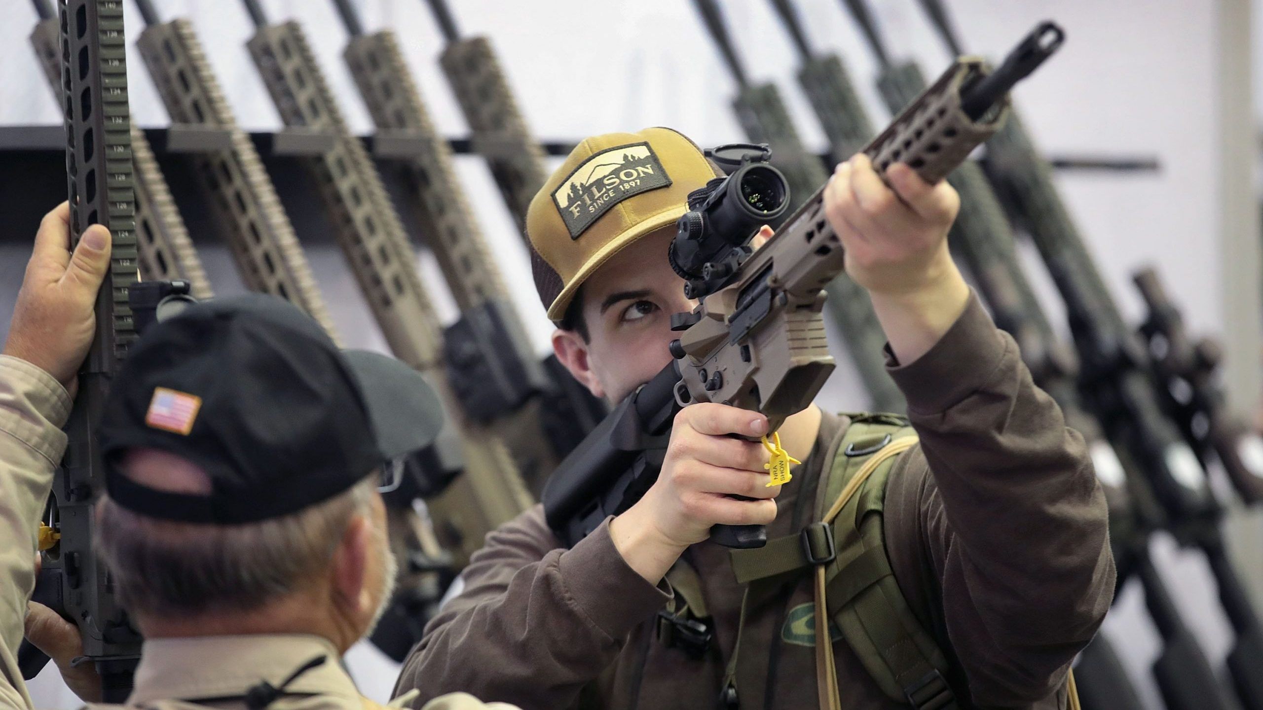 Guests look over rifle scopes at the 148th NRA Annual Meetings and Exhibits on April 27, 2019, in Indianapolis, Indiana. (Credit: Scott Olson/Getty Images)