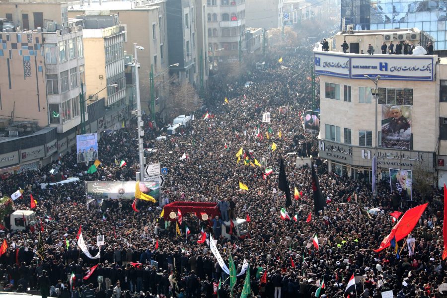 Iranian mourners take part in a funeral procession in the capital Tehran on January 6, 2020, for slain military commander Qasem Soleimani, Iraqi paramilitary chief Abu Mahdi al-Muhandis, and other victims of a US attack. (Credit: ATTA KENARE/AFP via Getty Images)