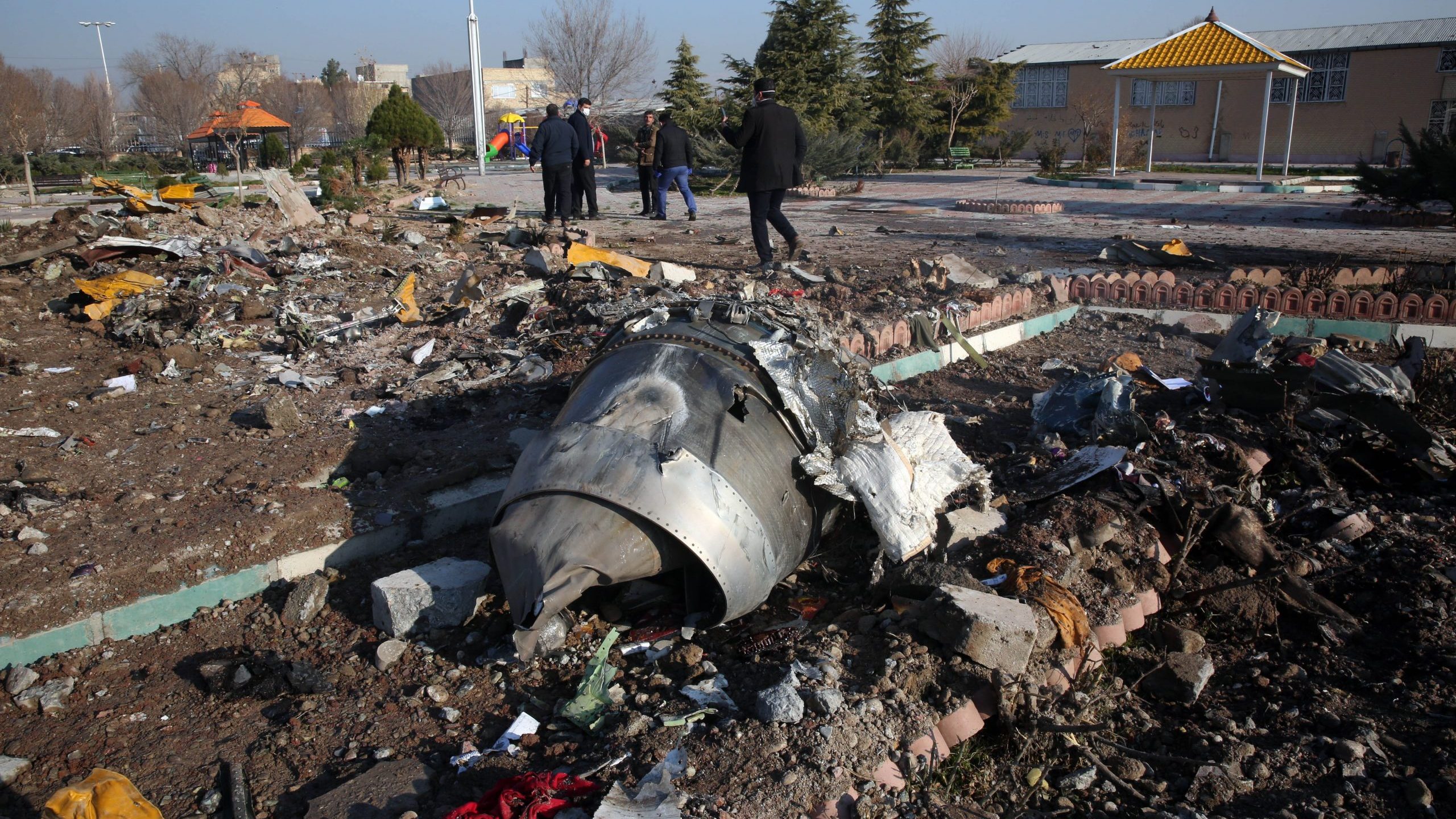 Rescue teams work amidst debris after a Ukrainian plane carrying 176 passengers crashed near Imam Khomeini airport in the Iranian capital Tehran early in the morning on Jan. 8, 2020, killing everyone on board. (Credit: AFP via Getty Images)