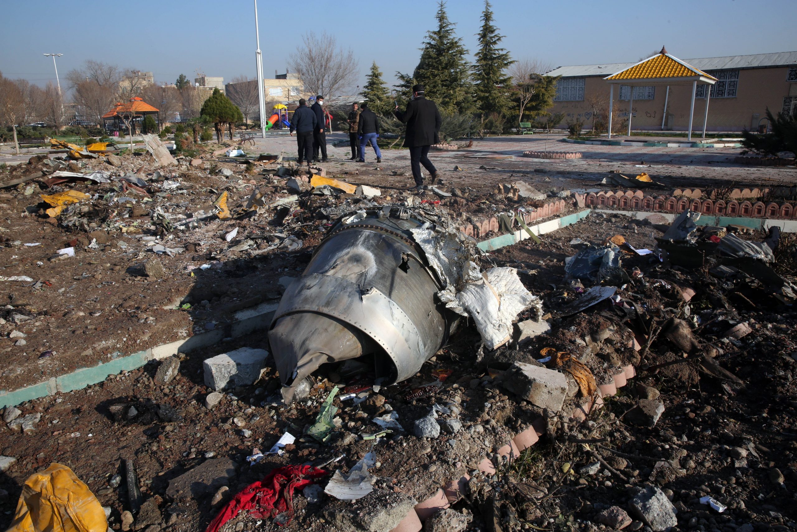 Rescue teams work amidst debris after a Ukrainian plane carrying 176 passengers crashed near Imam Khomeini airport in the Iranian capital Tehran early in the morning on Jan. 8, 2020, killing everyone on board. (Credit: AFP via Getty Images)