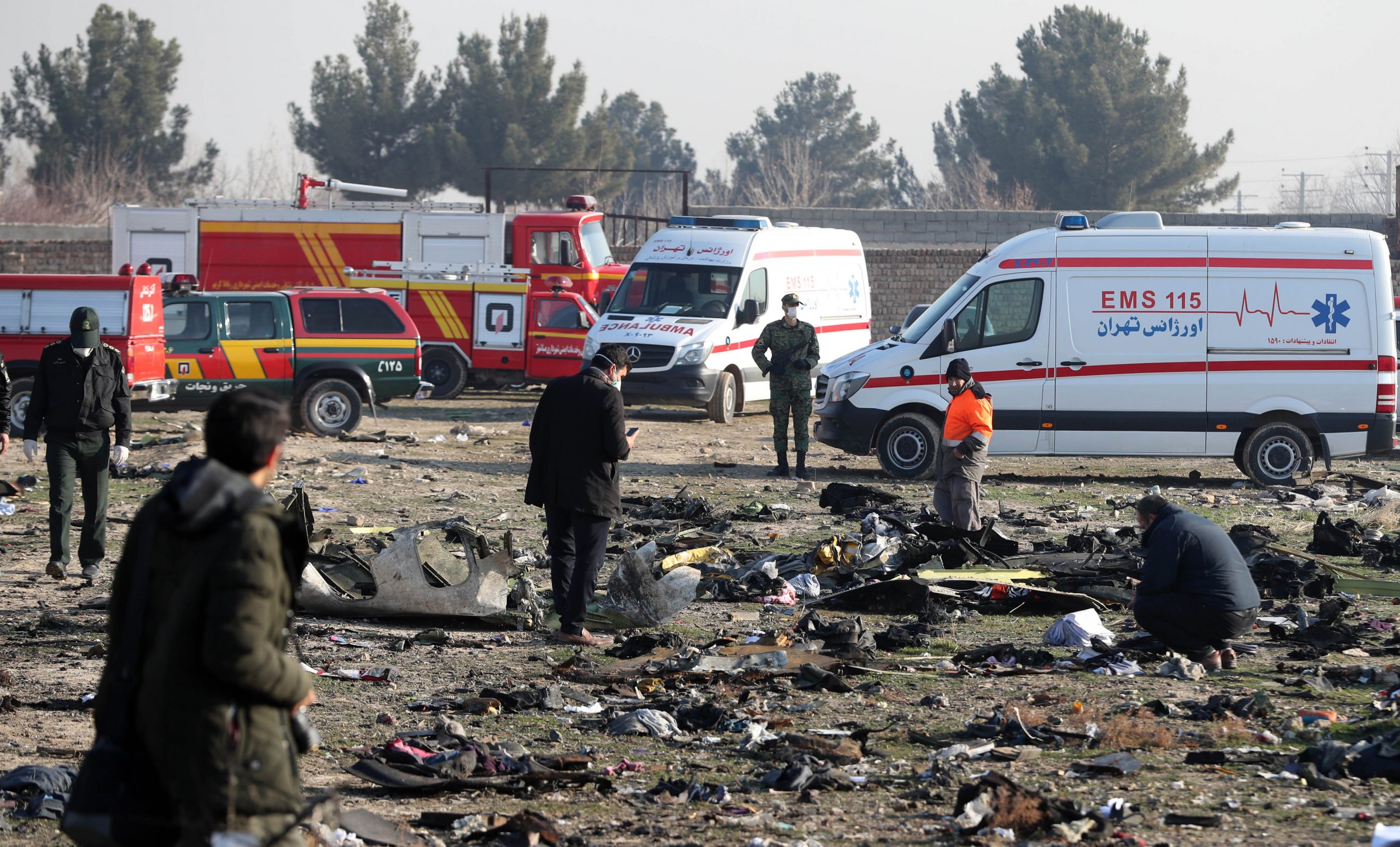 Rescue teams work amidst debris after a Ukrainian plane carrying 176 passengers crashed near Imam Khomeini airport in the Iranian capital Tehran early in the morning on January 8, 2020, killing everyone on board. (Credit: AFP via Getty Images)