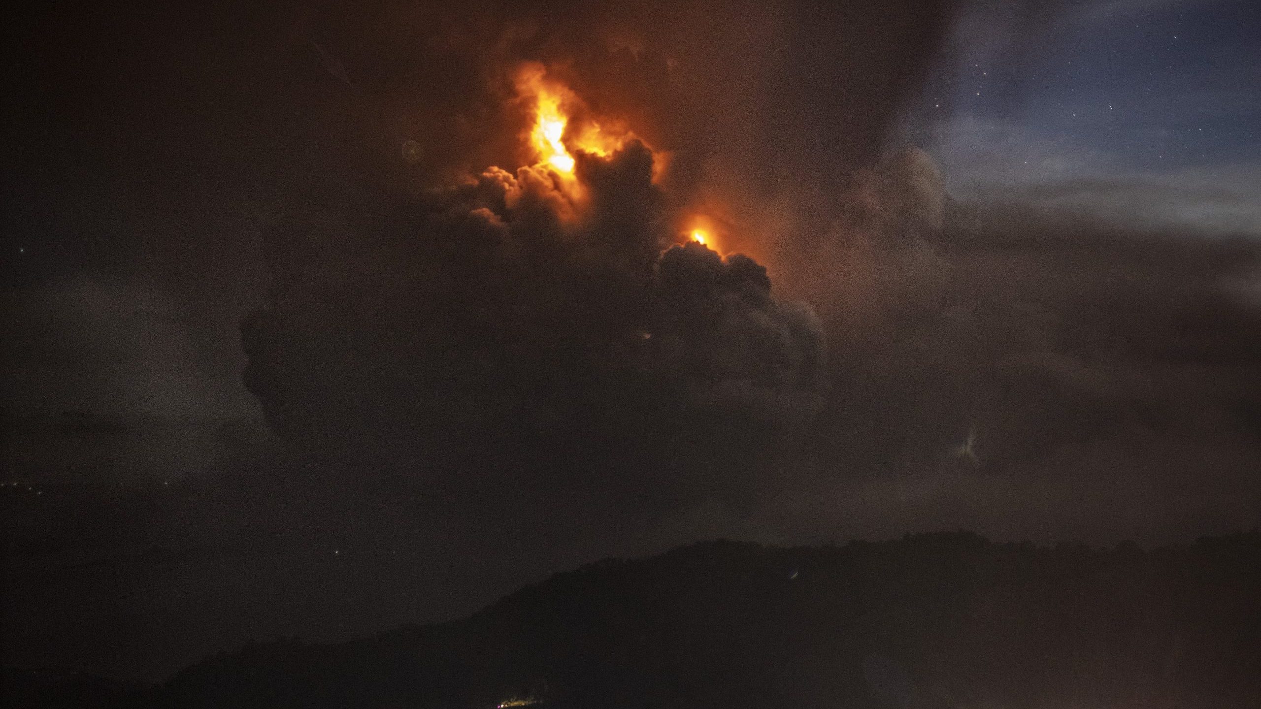 A column of ash surrounds the crater of Taal Volcano as it erupts on Jan. 12, 2020 as seen from Tagaytay City, Cavite province, Philippines. (Credit: Ezra Acayan/Getty Images)