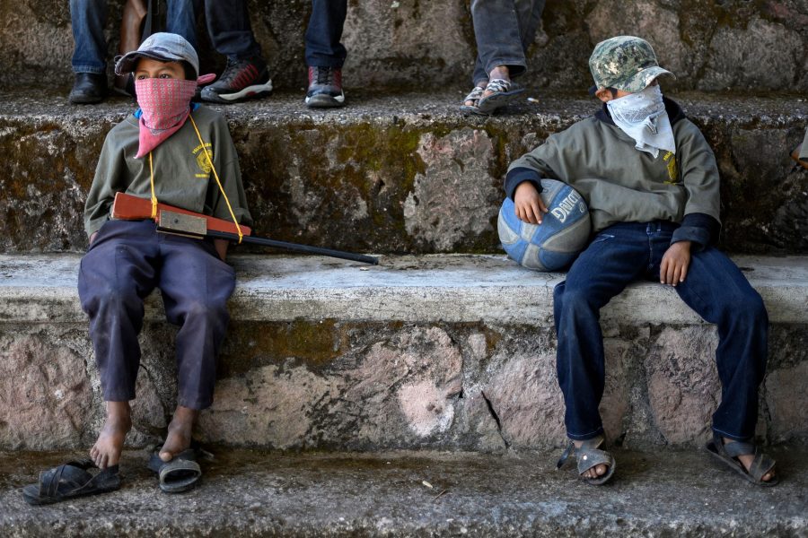 Children are tought to use weapons by the Regional Coordinator of Community Authorities (CRAC-PF) community police force at a basketball court in the village of Ayahualtempan, Guerrero State, Mexico, on Jan. 24, 2020. (Credit: PEDRO PARDO/AFP via Getty Images)