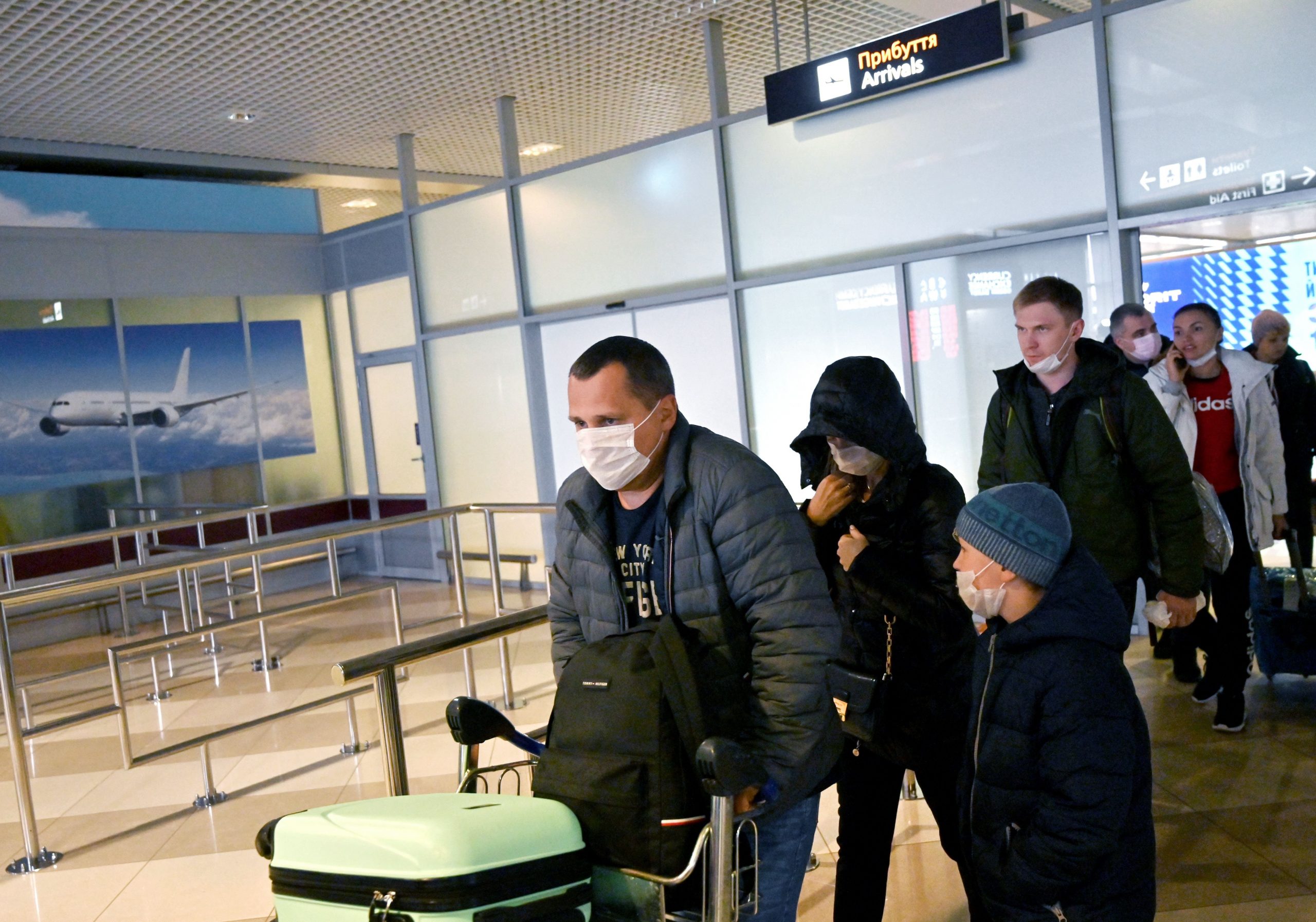 Ukrainian tourists walk in the arrival hall of the Internatioanal Boryspil airport outside Kiev after their plane landed from China on Jan. 30, 2020. The first out of four special flights will be held on Jan. 30, 2020, in order to evacuate hundreds of Ukrainian tourists from China as the deadly coronavirus outbreak grows. (Credit: SERGEI SUPINSKY/AFP via Getty Images)