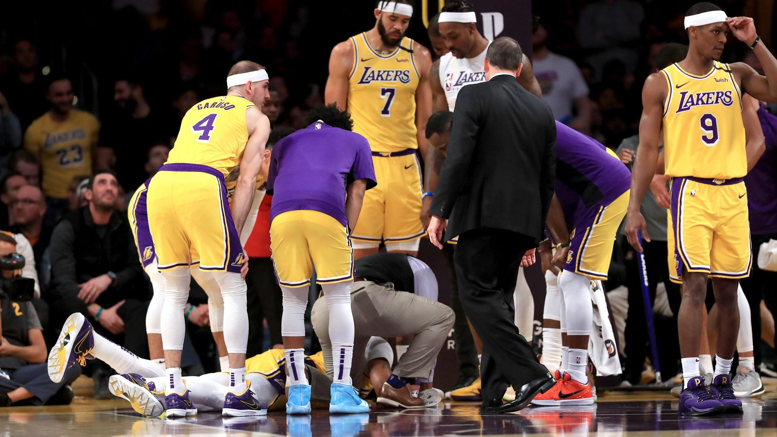 Los Angeles Lakers players Alex Caruso, JaVale McGee, Rajon Rondo and Dwight Howard surround Anthony Davis as he lies on the ground during a match against the New York Knicks at Staples Center on Jan. 7, 2020 in Los Angeles. (Credit: Sean M. Haffey/Getty Images)