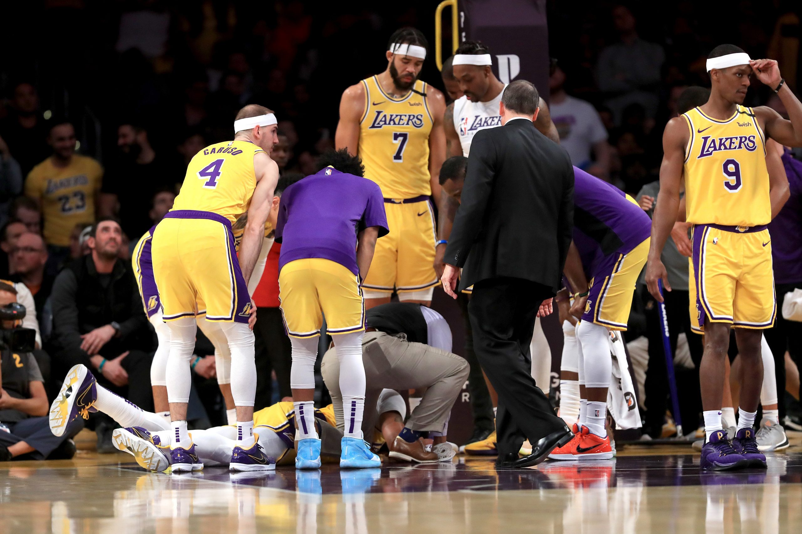 Los Angeles Lakers players Alex Caruso, JaVale McGee, Rajon Rondo and Dwight Howard surround Anthony Davis as he lies on the ground during a match against the New York Knicks at Staples Center on Jan. 7, 2020 in Los Angeles. (Credit: Sean M. Haffey/Getty Images)