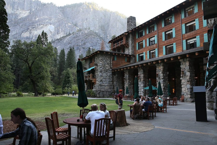 Park visitors sit outside the Ahwahnee Hotel in Yosemite National Park on Aug. 28, 2013. (Credit: Justin Sullivan / Getty Images)