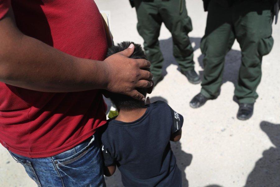 U.S. Border Patrol agents take a father and son from Honduras into custody near the U.S.-Mexico border on June 12, 2018 near Mission, Texas.(Credit: John Moore/Getty Images)