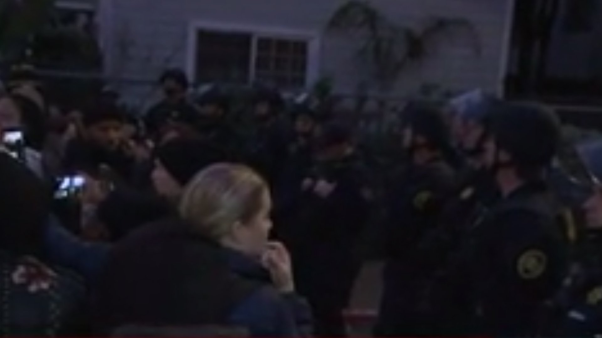 Armed deputies and protesters outside a home where four squatting mothers were evicted on Jan. 14, 2020. (Credit: KPIX via CNN)