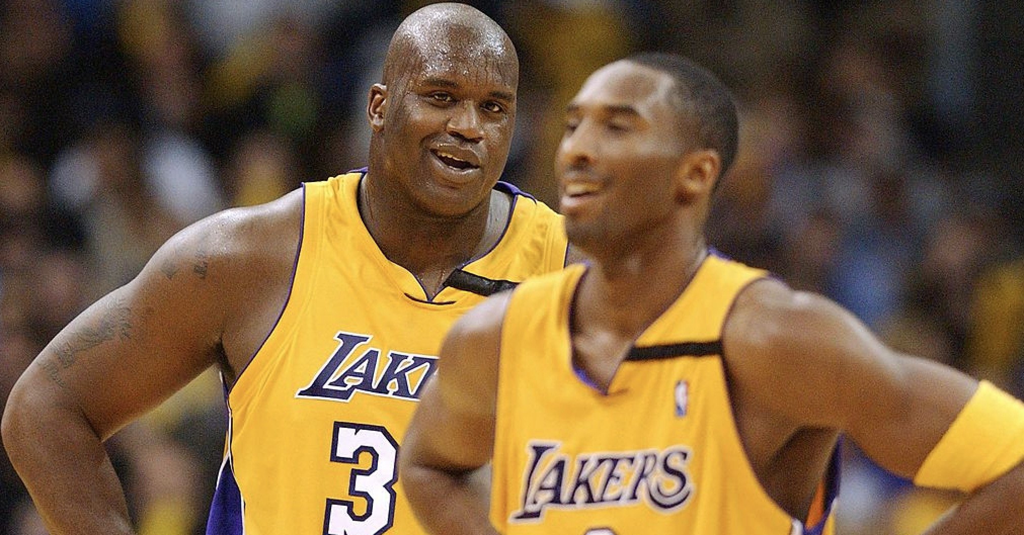 Los Angeles Lakers' center Shaquille O'Neal laughs with guard Kobe Bryant during the Lakers' 86-73 win against the Chicago Bulls in L.A. on Nov. 22, 2002. (Credit: Lucy Nicholson / AFP / Getty Images)