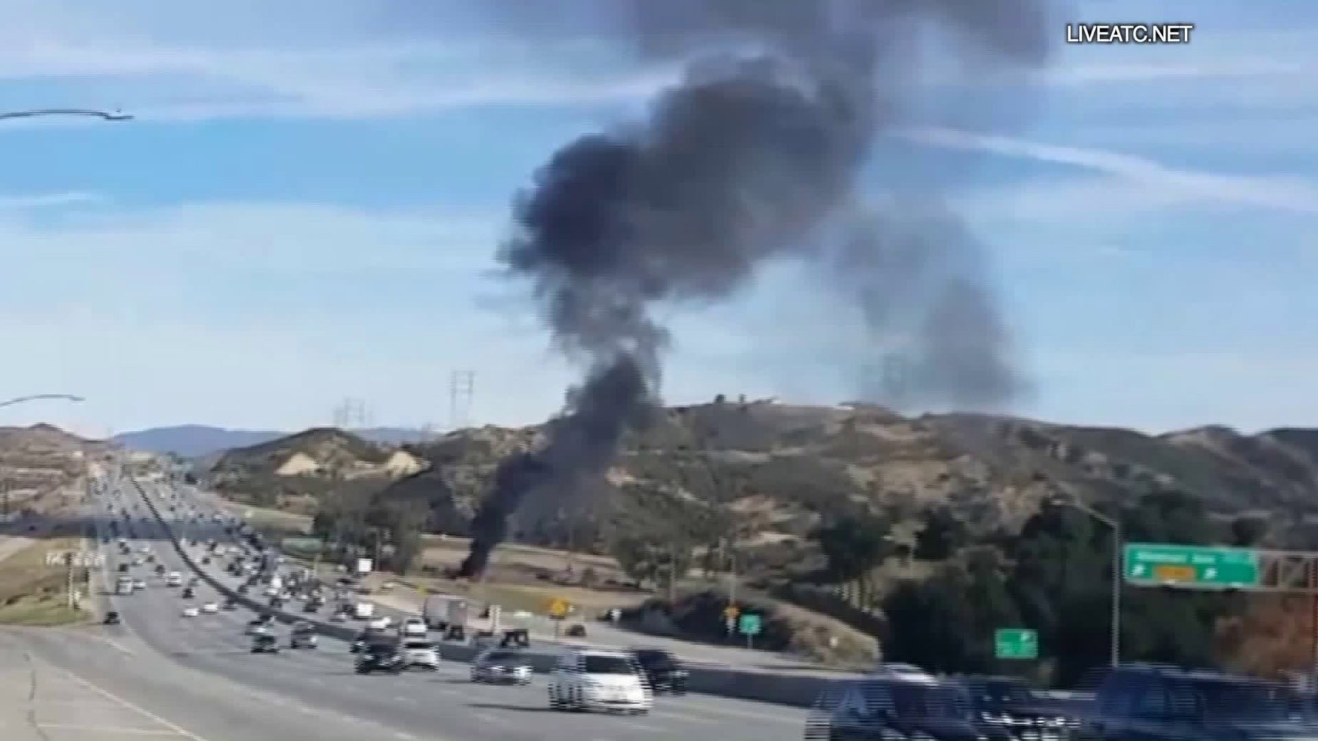 Black smoke rises from a small plane that crashed near the 14 Freeway in Santa Clarita on Jan. 4, 2019. (Credit: Liveatc.net)