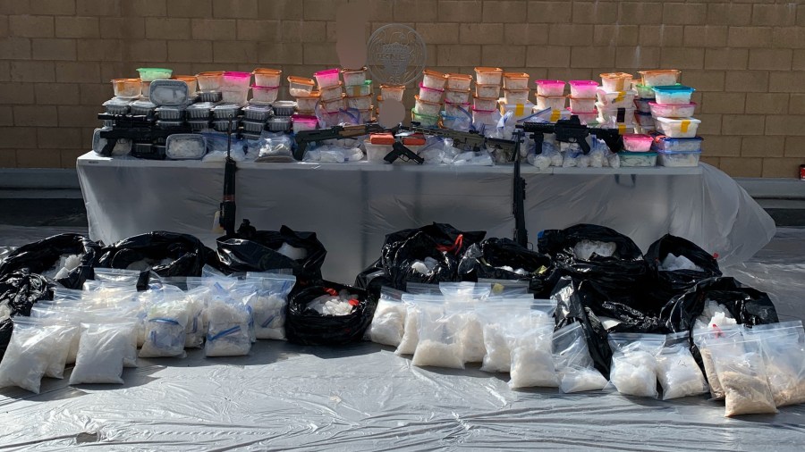 Law enforcement officials display drugs and guns seized during a bust in San Bernardino on Feb. 20, 2020. (Credit: U.S. Drug Enforcement Administration)