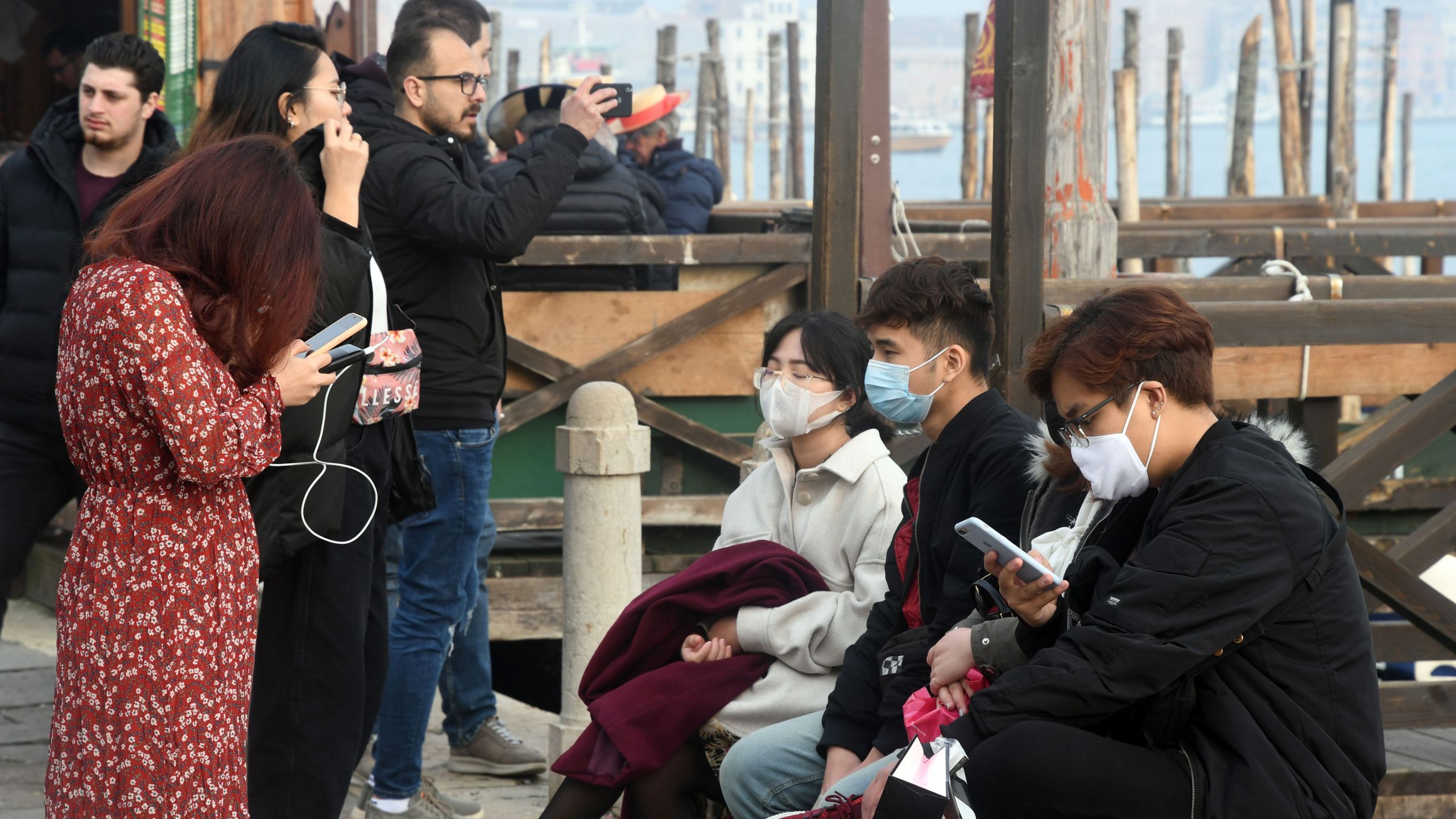 Tourists wearing protective masks visit Venice on Feb. 25, 2020, during the usual period of Carnival festivities which were cancelled due to a coronavirus outbreak in northern Italy. (Credit: Andrea Pattaro / AFP / Getty Images)