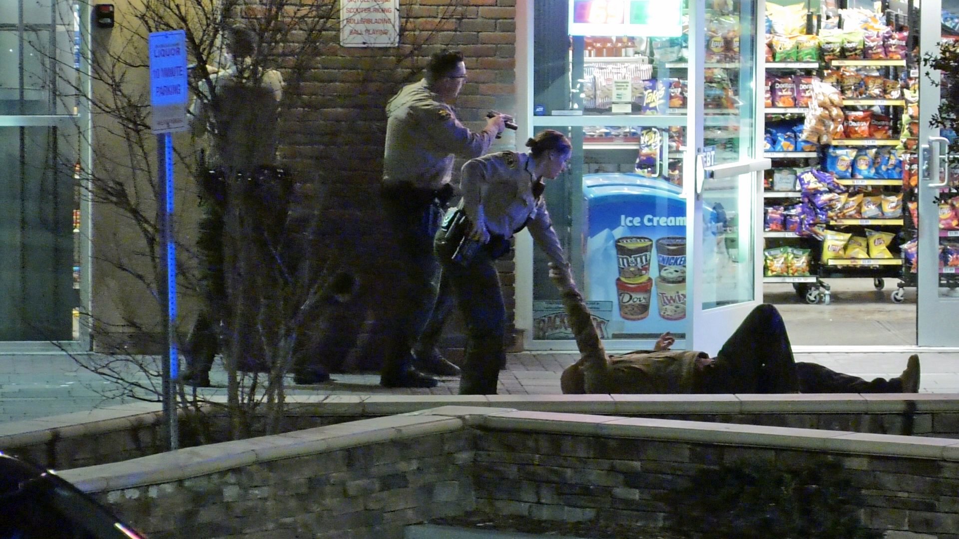 Deputies respond to the scene of a gunfight in which a shopkeeper was wounded and an alleged robber was killed at a Santa Clarita liquor store on Feb. 2, 2020. (Credit: Austin Dave)