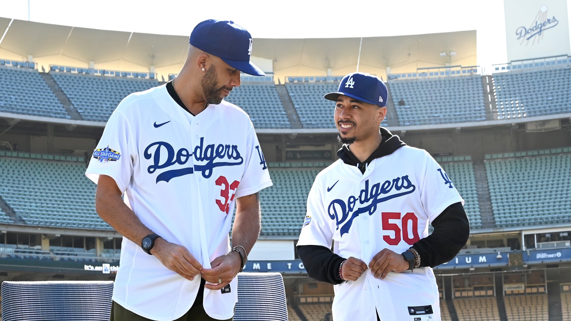 Los Angeles Dodgers David Price, left, and Mookie Betts adjust their jerseys as they are introduced at Dodger Stadium on Feb. 12, 2020. (Credit: Jayne Kamin-Oncea / Getty Images)