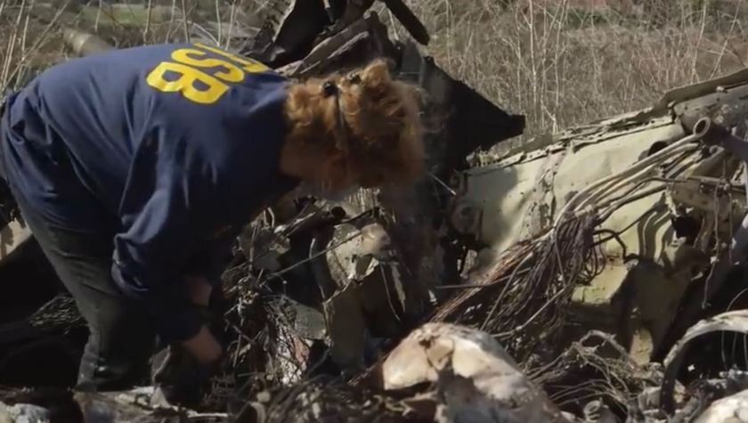 An NTSB investigator examines the helicopter crash site following the death of Kobe Bryant and eight others. (Credit: Los Angeles Times)