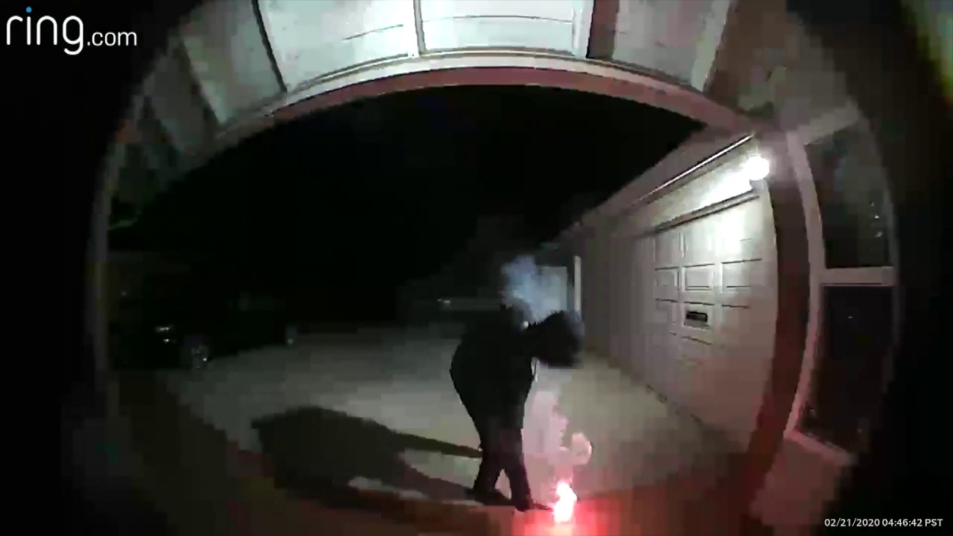 This still from footage provided to KTLA on Feb. 22, 2020, shows a man lighting a flare at a couple's home in Cerritos.