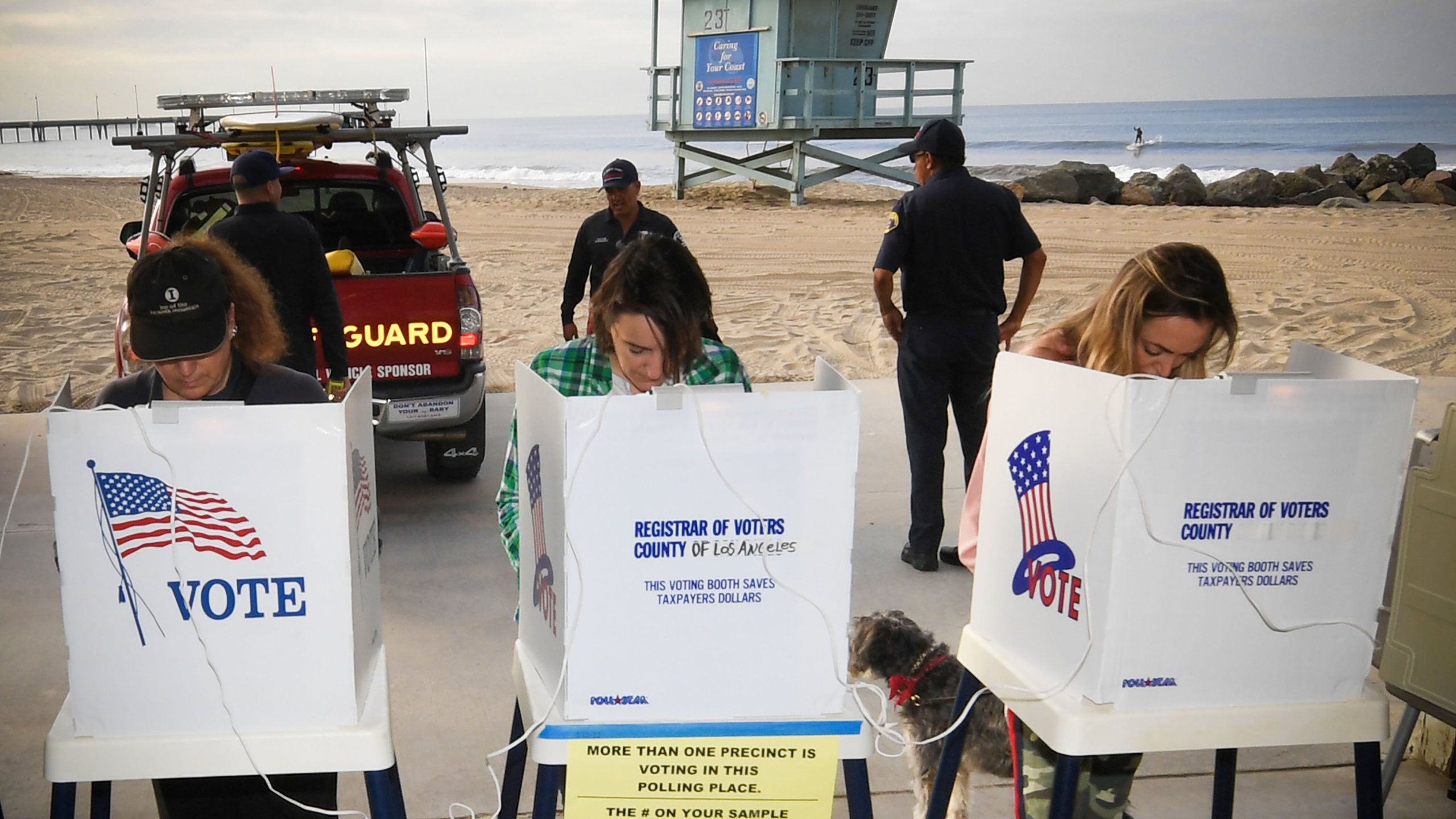 People vote near a Venice Beach lifeguard station on Nov. 6, 2018. (Credit: Mark Ralston /AFP / Getty Images)