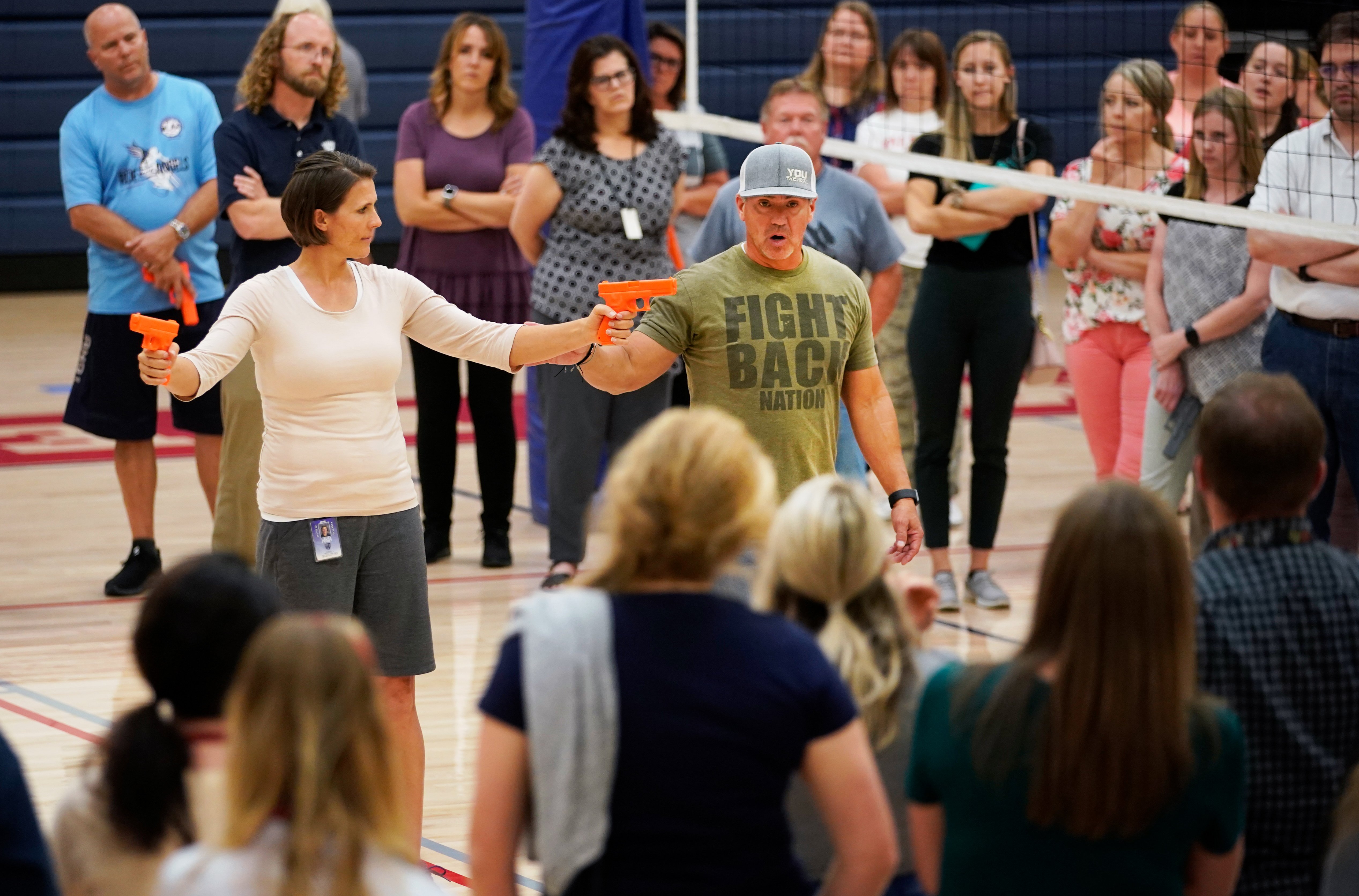 A man uses dummy handguns as he demonstrates with a teacher how to disarm a shooter and fight back during an active shooter event on Sept. 4, 2019, in Provo, Utah. (Credit: George Frey/Getty Images)