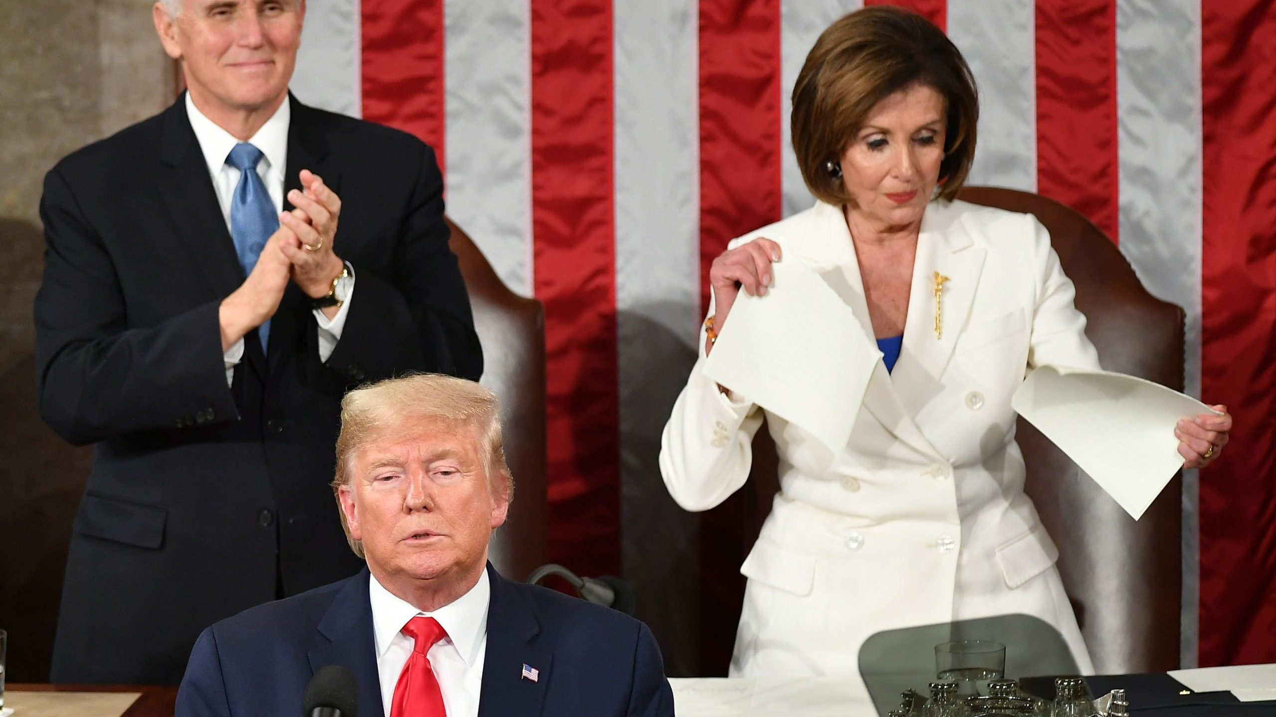 US Vice President Mike Pence claps as Speaker of the US House of Representatives Nancy Pelosi appears to rip a copy of US President Donald Trumps speech after he delivers the State of the Union address at the US Capitol in Washington, DC, on February 4, 2020. (Credit: MANDEL NGAN/AFP via Getty Images)