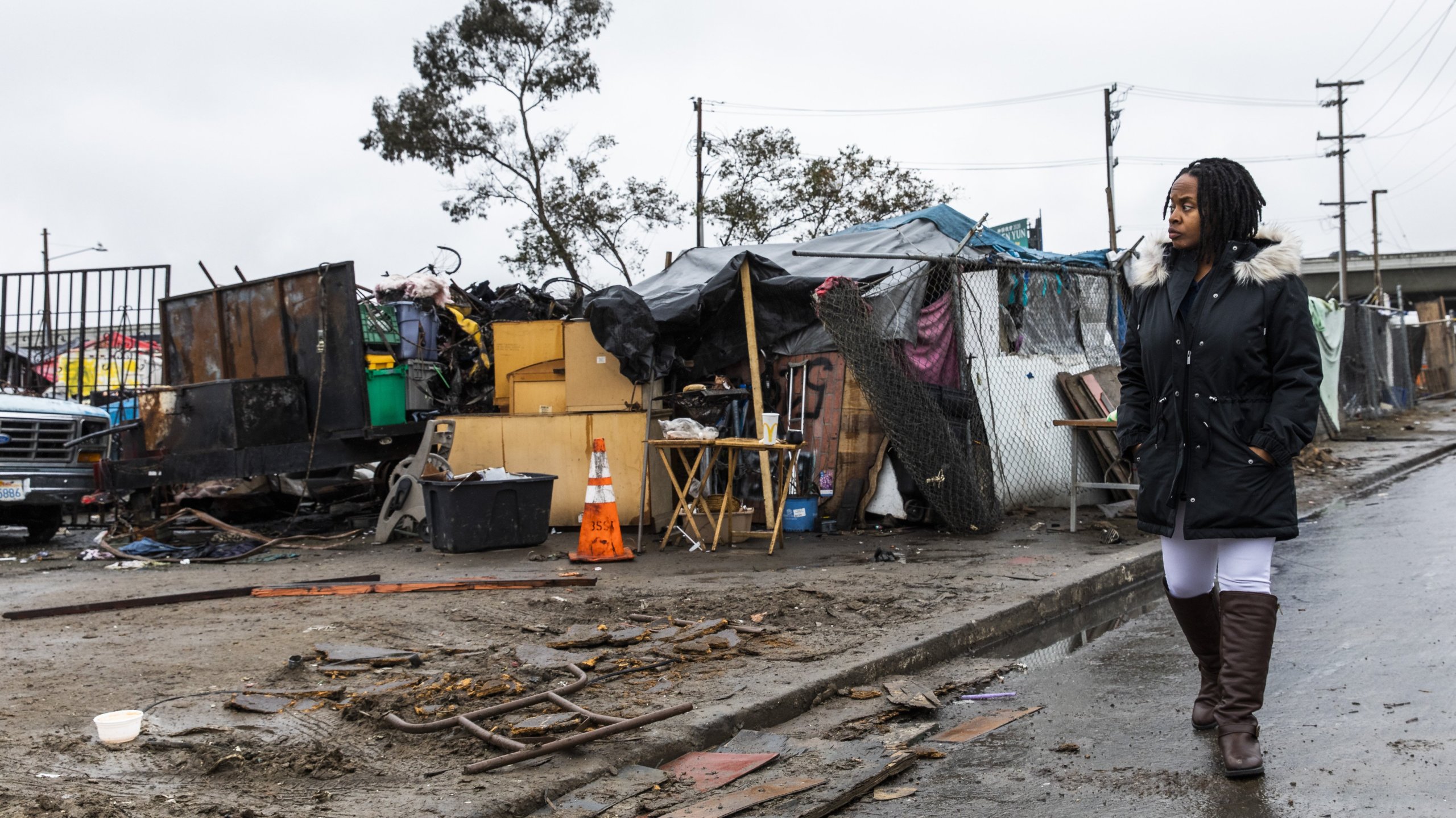 Carroll Fife, the director of the Oakland office for the Alliance of Californians for Community Empowerment, walks outside a homeless encampment in Oakland on Jan. 28, 2020. (Credit: Philip Pacheco / AFP / Getty Images)