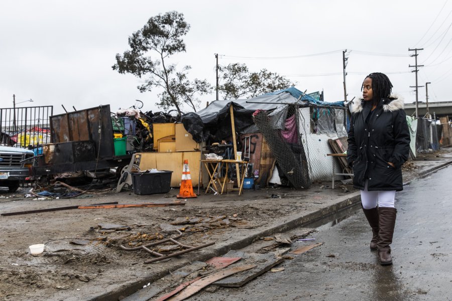 Carroll Fife, the director of the Oakland office for the Alliance of Californians for Community Empowerment, walks outside a homeless encampment in Oakland on Jan. 28, 2020. (Credit: Philip Pacheco / AFP / Getty Images)