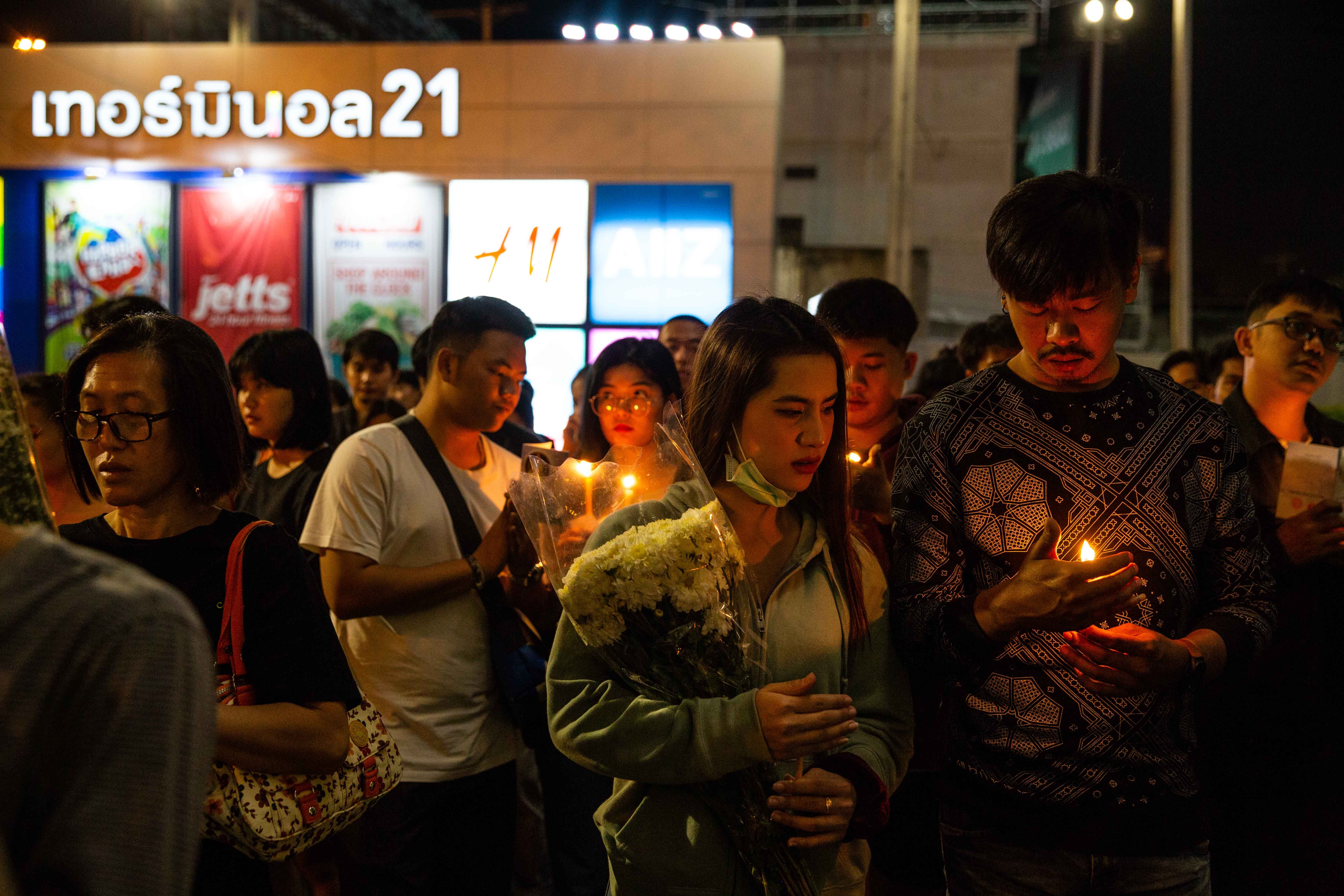 Thai mourners hold candles during a vigil following a mass shooting at Terminal 21 Mall on Feb. 10, 2020 in Korat, Thailand. (Credit: Lauren DeCicca/Getty Images)