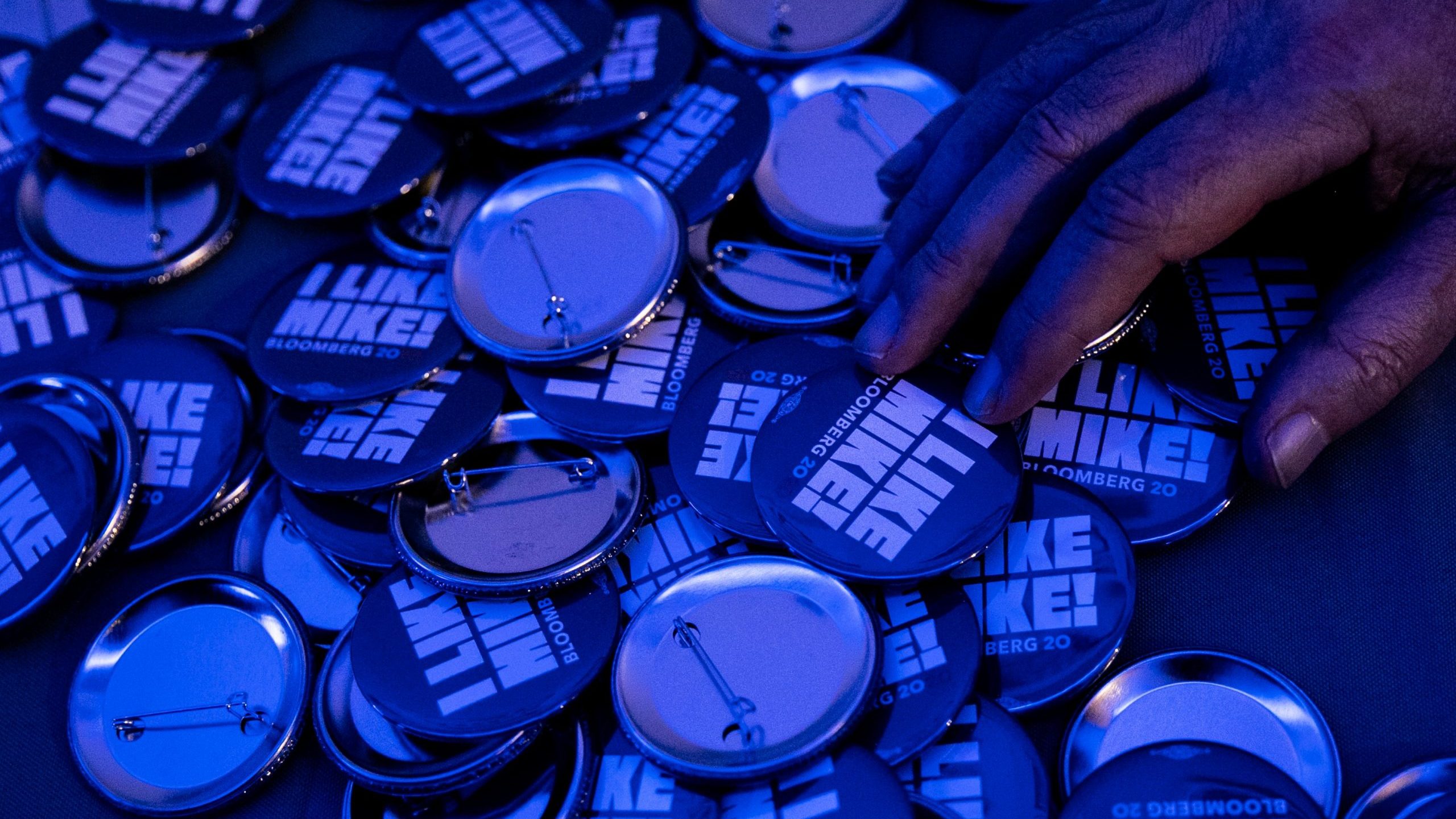 Mike Bloomberg 2020 campaign pins are seen during a debate watch party at Brooklyn field office on Feb. 19, 2020, in New York City. (Credit: Jeenah Moon/Getty Images)