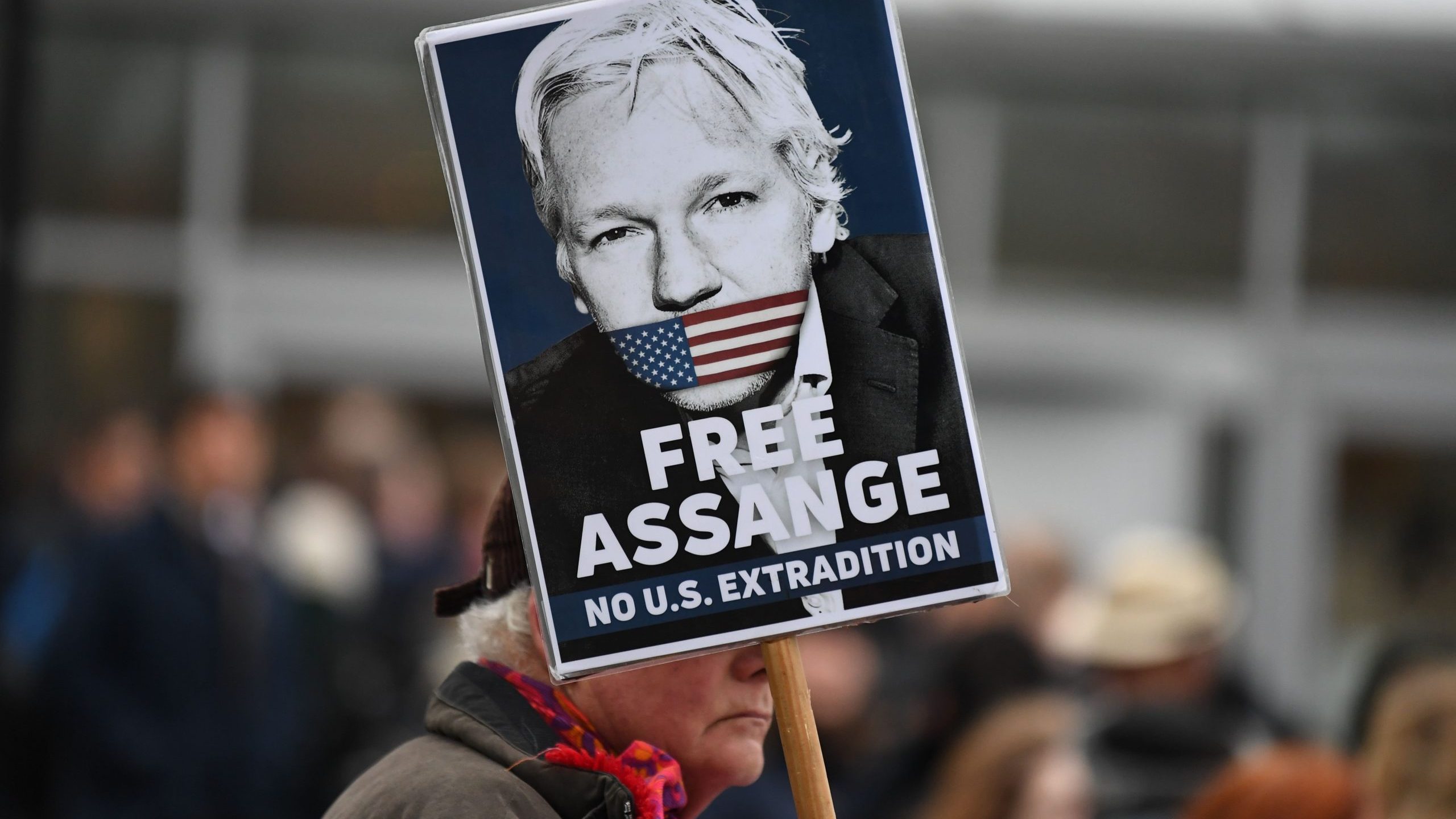 A supporter of WikiLeaks founder Julian Assange holds a placard calling for his freedom outside Woolwich Crown Court and HMP Belmarsh prison in southeast London on Feb. 24, 2020, ahead of the opening of the trial to hear a U.S. request for Assange's extradition. (Credit: DANIEL LEAL-OLIVAS/AFP via Getty Images)