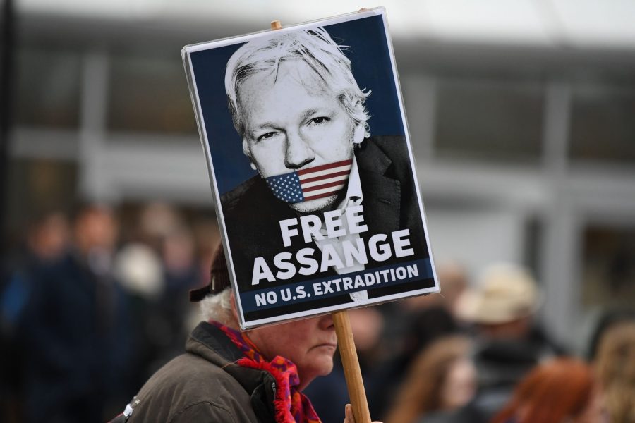 A supporter of WikiLeaks founder Julian Assange holds a placard calling for his freedom outside Woolwich Crown Court and HMP Belmarsh prison in southeast London on Feb. 24, 2020, ahead of the opening of the trial to hear a U.S. request for Assange's extradition. (Credit: DANIEL LEAL-OLIVAS/AFP via Getty Images)