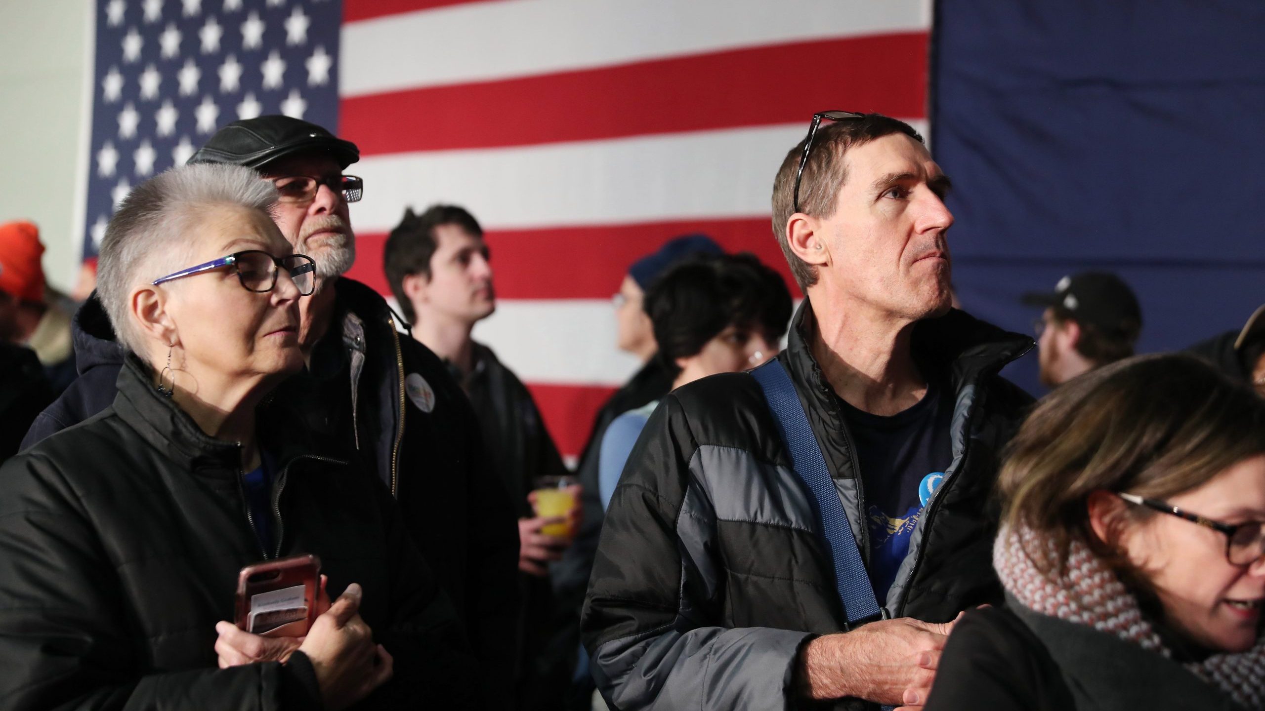 Supporters of democratic presidential candidate Sen. Bernie Sanders wait for results to come in at his caucus night watch party in Des Moines, Iowa, on Feb. 3, 2020. (Credit: Joe Raedle / Getty Images)