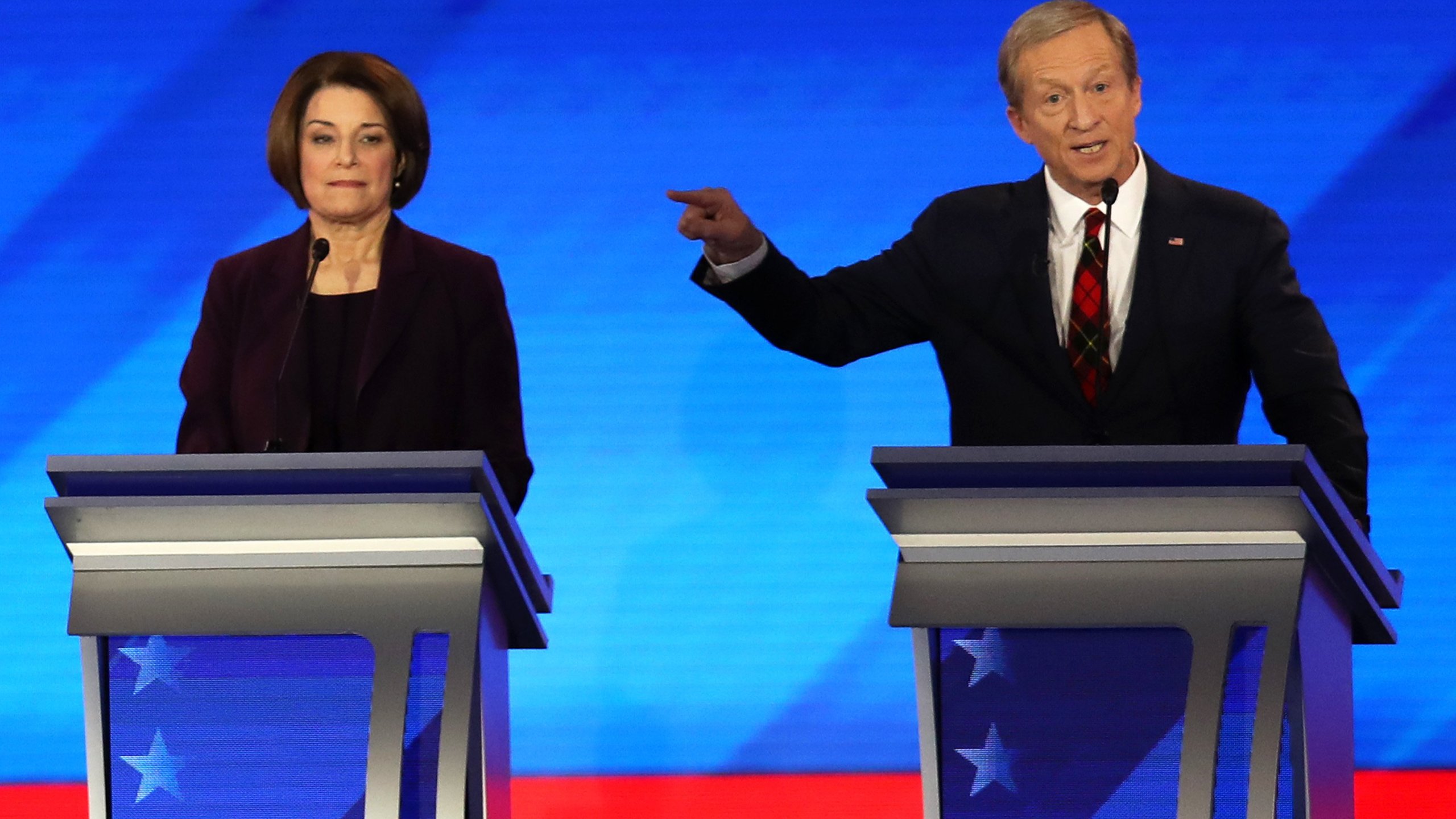 Democratic presidential candidates Sen. Amy Klobuchar (D-MN) and Tom Steyer participate in the Democratic presidential primary debate in the Sullivan Arena at St. Anselm College on Feb. 7, 2020, in Manchester, New Hampshire. (Credit: Joe Raedle/Getty Images)