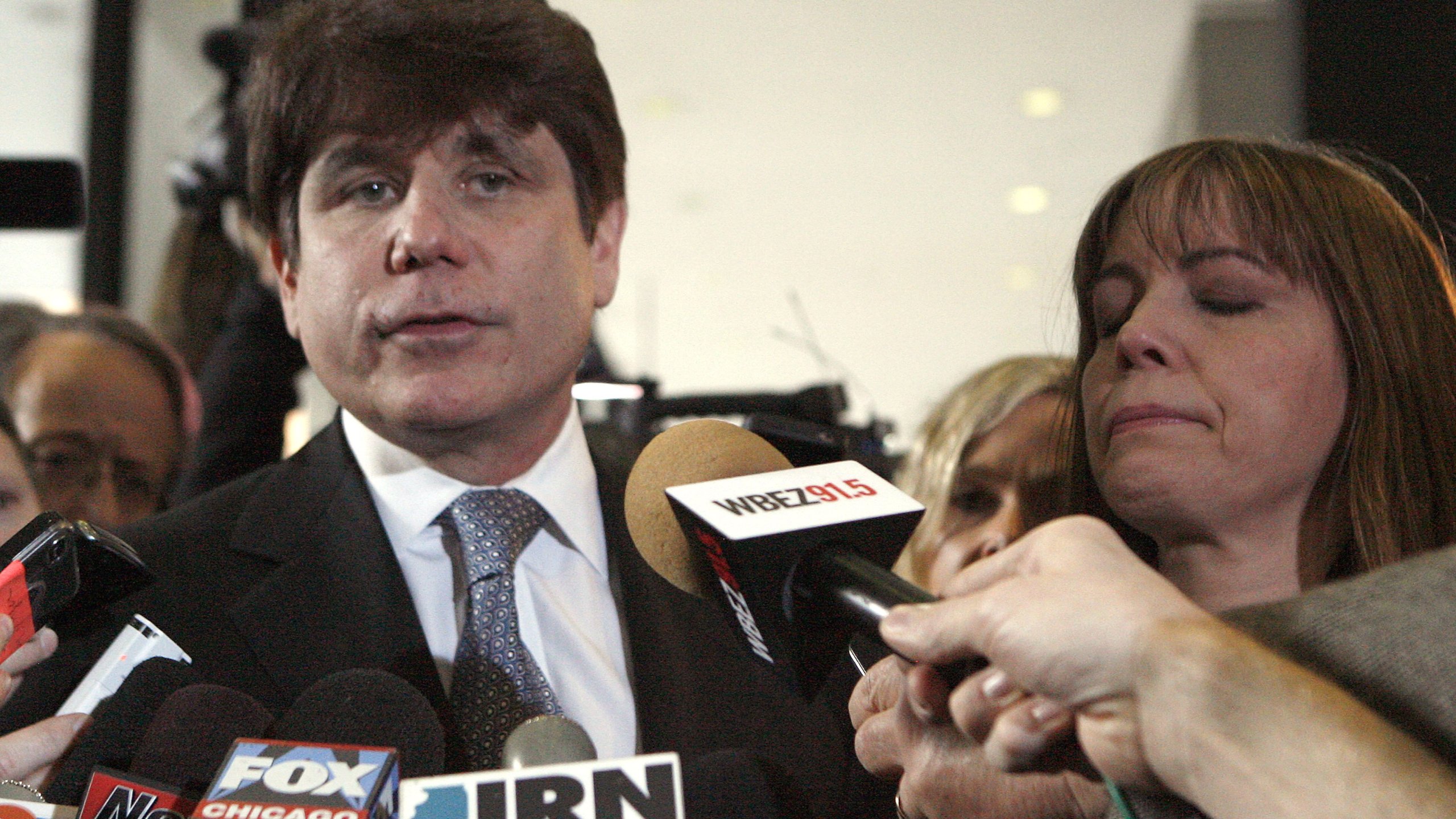 Former Illinois Gov. Rod Blagojevich addresses the media while wife Patti Blagojevich holds back tears at the Dirksen Federal Building Dec. 7, 2011, in Chicago, Ill. (Credit: Frank Polich/Getty Images)