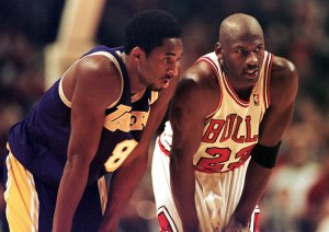 Kobe Bryant, left, and Michael Jordan, right, talk during a free-throw attempt during the fourth quarter at the United Center in Chicago on Dec. 17, 1997. (Credit: VINCENT LAFORET/AFP via Getty Images)