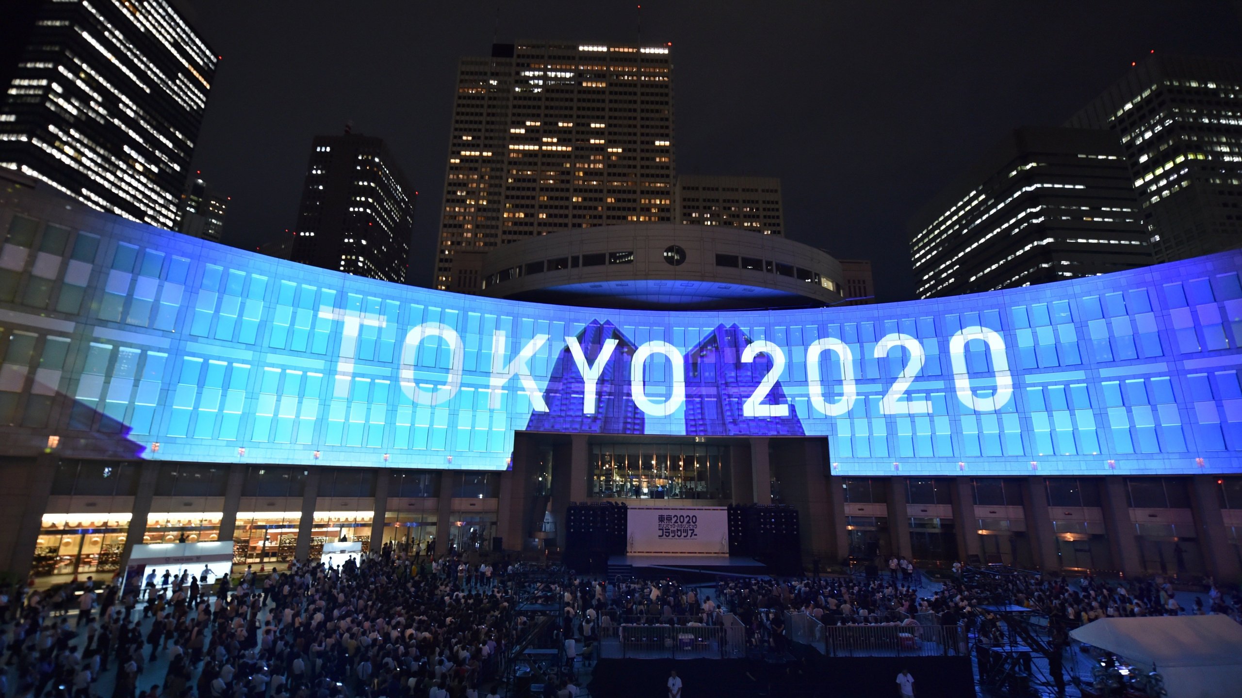 A projection that reads "Tokyo 2020" is seen during a ceremony marking three years to go before the start of the Tokyo 2020 Olympic games at the Tokyo Metropolitan Assembly Building on July 24, 2017. (Credit: KAZUHIRO NOGI/AFP via Getty Images)