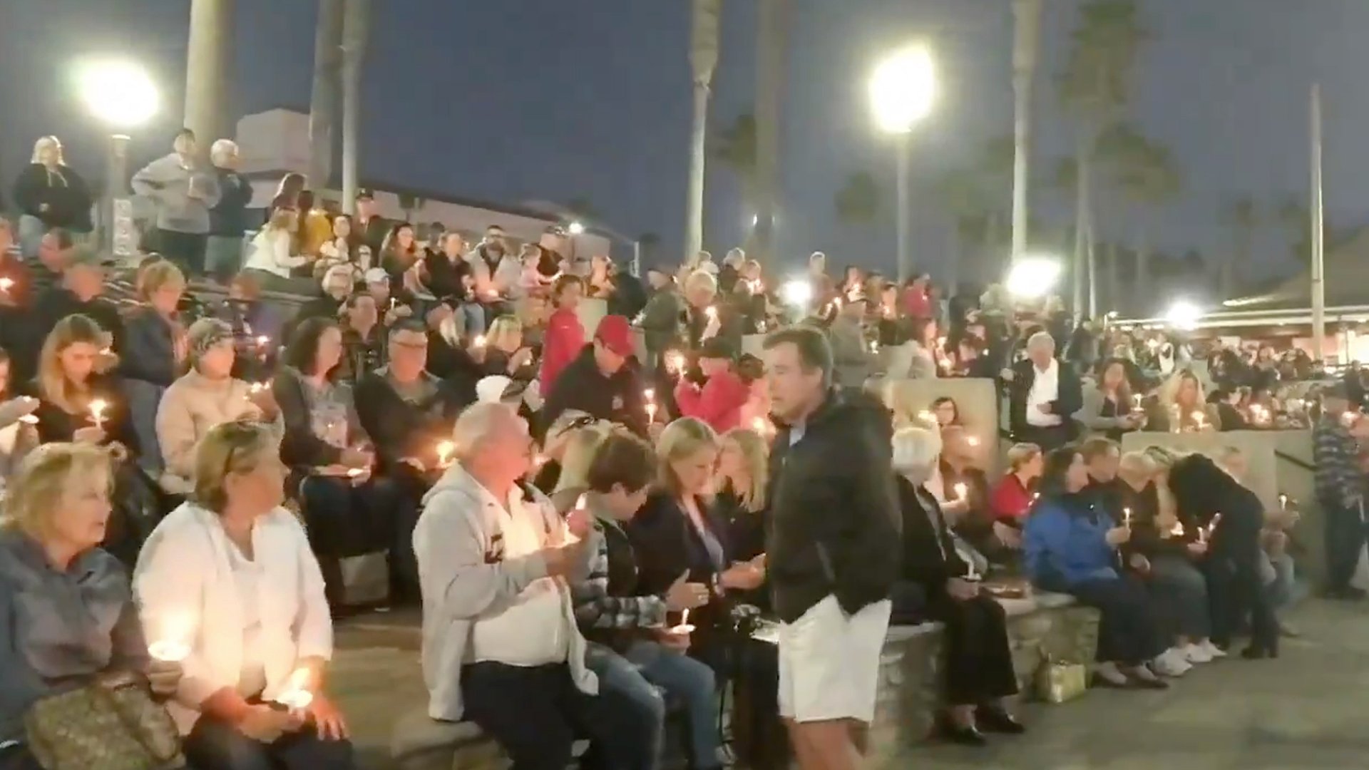 Mourners gather to pay their respects to helicopter crash victim Christina Mauser of Huntington Beach on the Huntington Beach Pier on Feb. 1, 2020. (Credit: City of Huntington Beach)