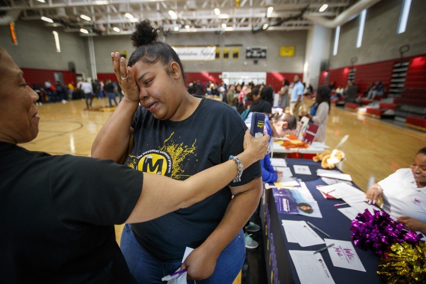 Lisa Fears-Hackett, manager of education programs at the National College Resources Foundation, congratulates Kaneisha Johnson on her acceptance into Paul Quinn College in Dallas in January 2020. (Credit: Allen J. Schaben / Los Angeles Times)