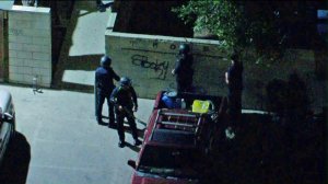 Los Angeles police officers search for a homicide suspect after a pursuit came to an end in Panorama City on Feb. 24, 2020. (Credit: KTLA)