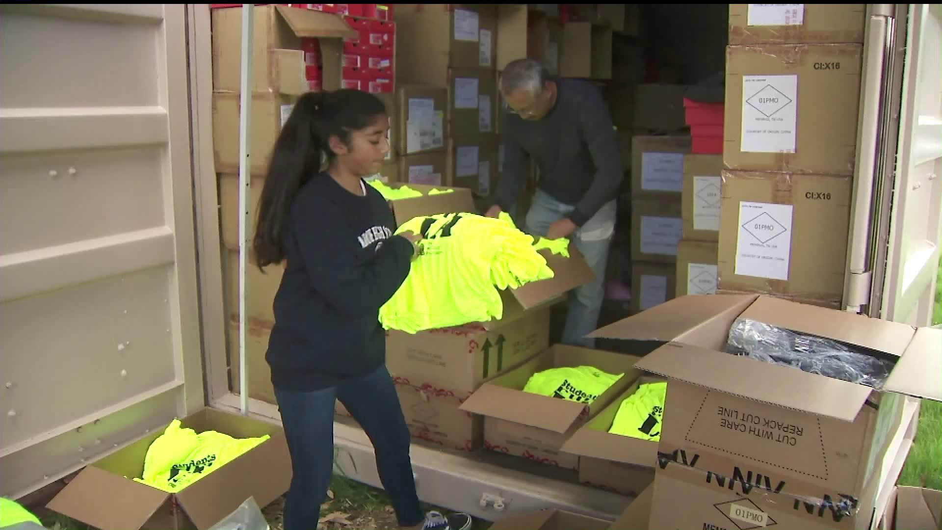 Students Run L.A. volunteers distribute uniforms to be sported by more than 3,000 students who will be running in the upcoming Los Angeles Marathon. (Credit: KTLA)