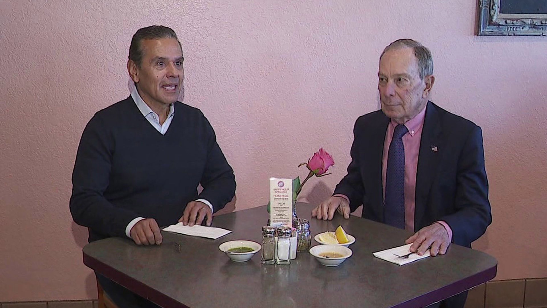 Former Los Angeles Mayor Antonio Villaraigosa and Michael R. Bloomberg sit at a restaurant together. (Credit: KTLA)