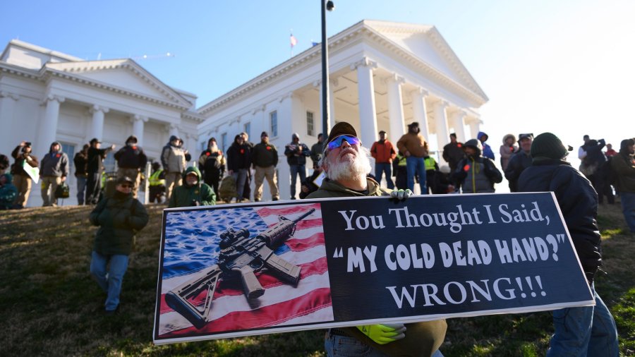 A pro-gun demonstrator holds a sign outside the Virginia State Capitol in Richmond on Jan. 20, 2020. (Credit: Roberto Schmidt / AFP/ Getty Images)