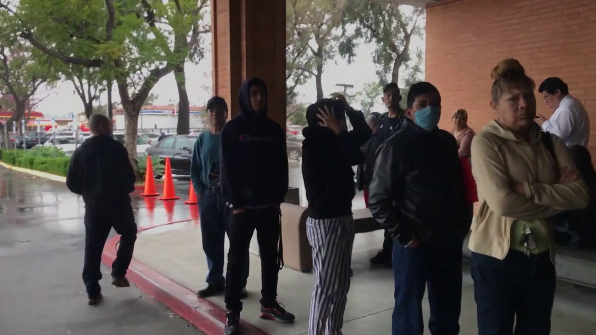 People line up at the Department of Motor Vehicles location in Santa Ana as risks of spreading COVID-19 trigger the closures of schools and stores elsewhere March 16, 2020.