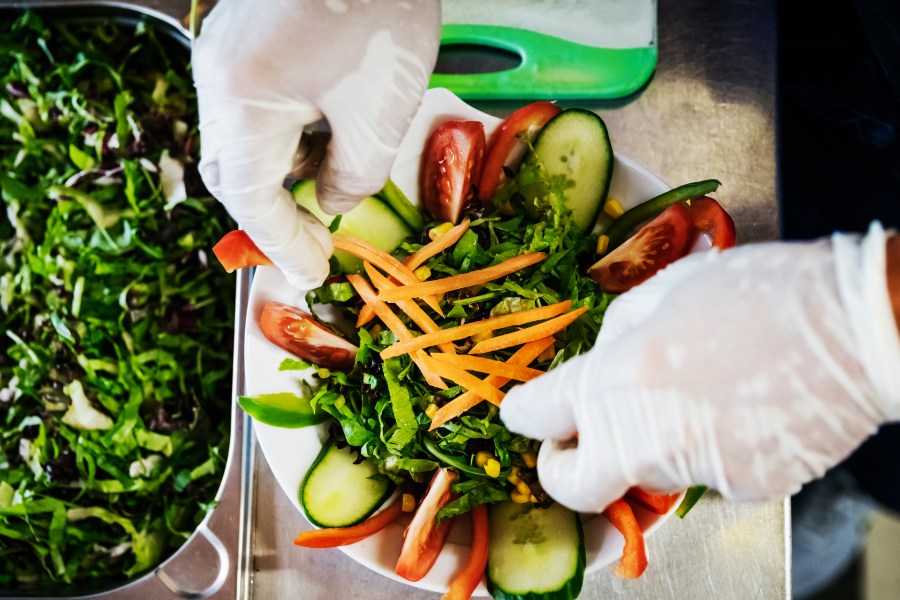 A worker is preparing some salad dishes in this file photo. (Getty Images)