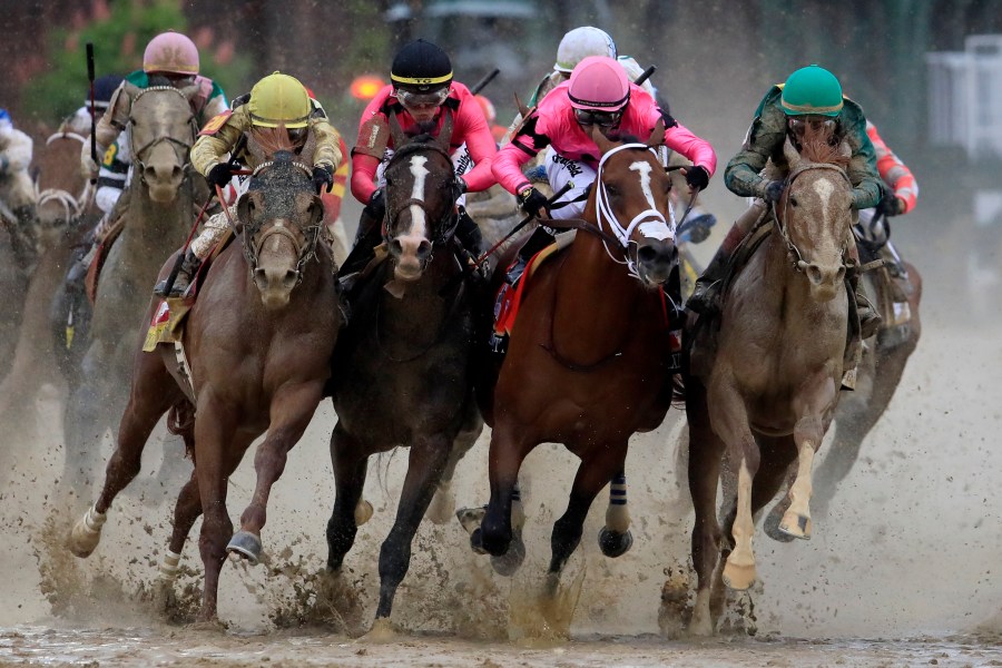 Country House, War of Will, Maximum Security and Code of Honor fight for position in the final turn during the 145th running of the Kentucky Derby in Louisville on May 4, 2019. (Credit: Andy Lyons / Getty Images)