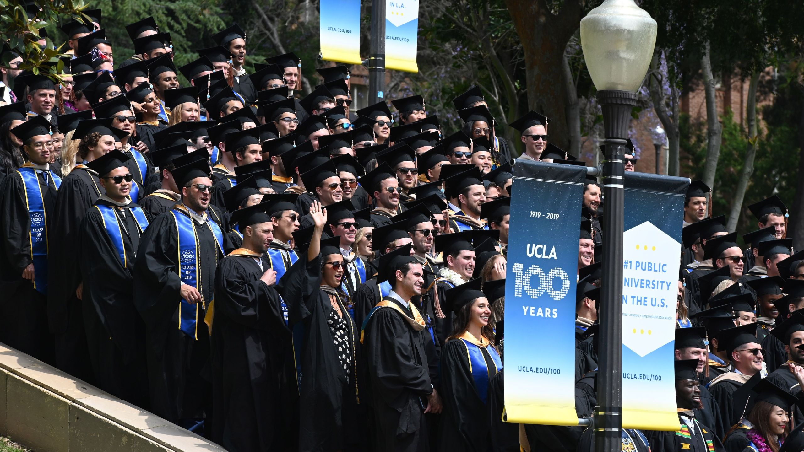 Graduating students pose for a class picture at UCLA on June 14, 2019. (ROBYN BECK/AFP via Getty Images)