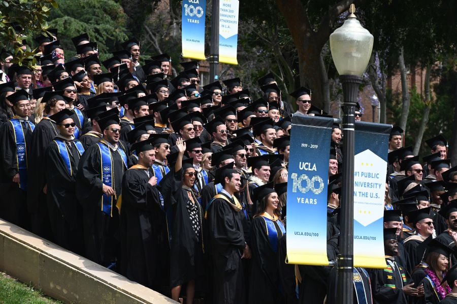 Graduating students pose for a class picture at UCLA on June 14, 2019. (ROBYN BECK/AFP via Getty Images)