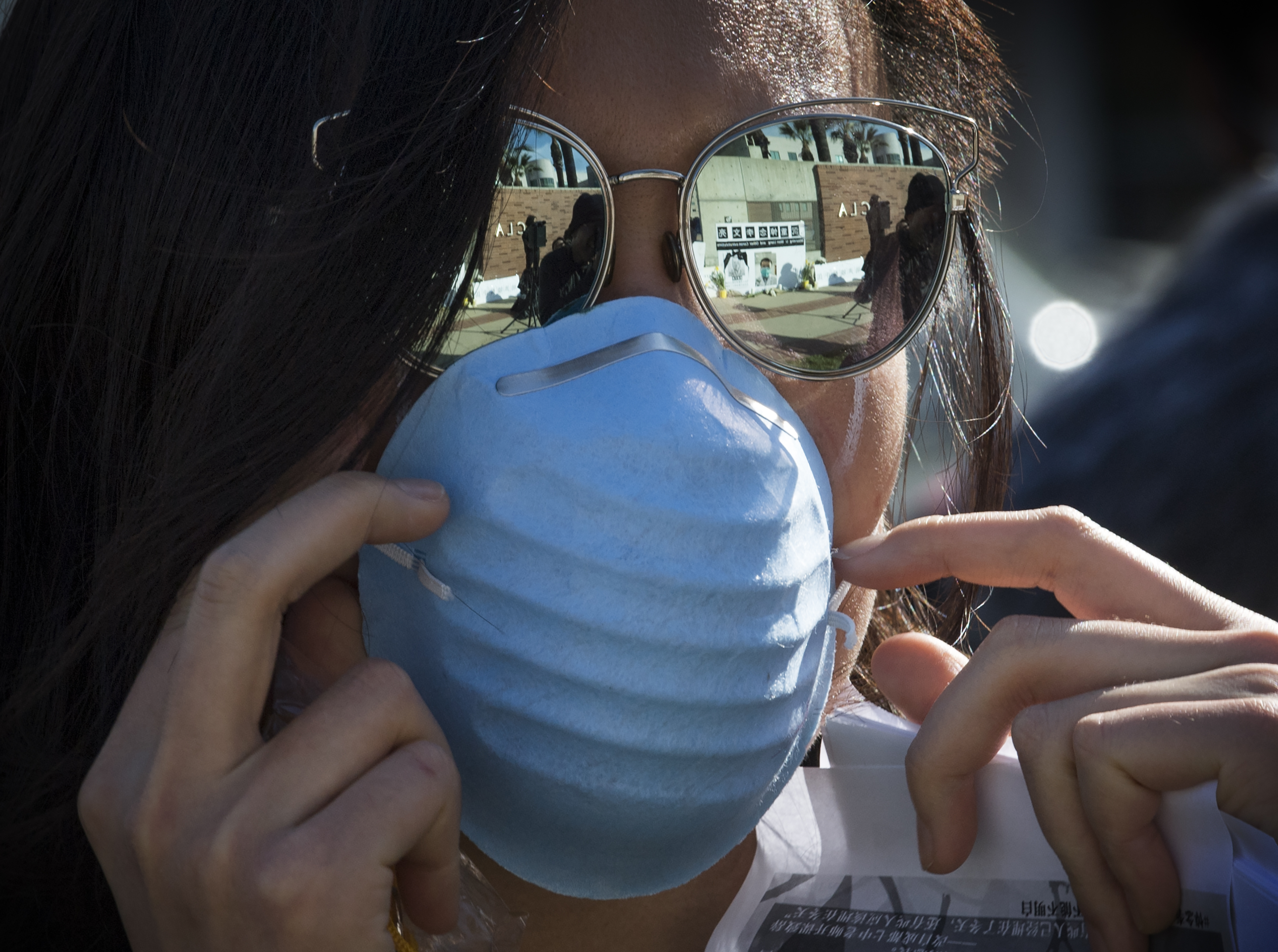 A student is seen wearing a face mask outside the UCLA campus in this file photo. (Credit: MARK RALSTON/AFP via Getty Images)